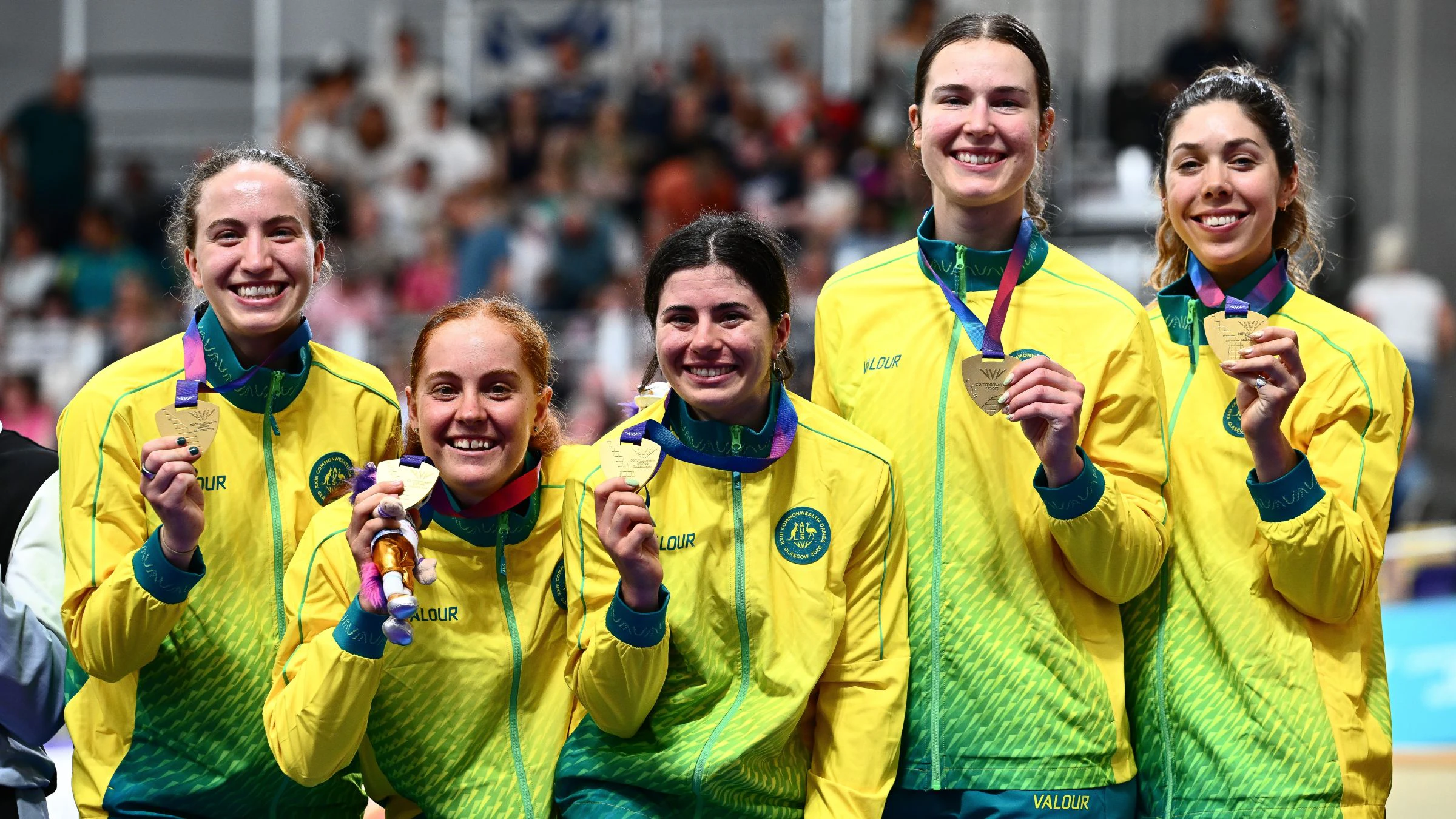 Australia's Alyssa Polites, Claudia Marcks, Georgia Baker, Sophie Edwards and Felicity Wilson-Haffenden on the podium of the Glasgow 2026 Commonwealth Games women's team pursuit