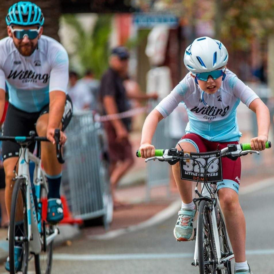 A young Perth cyclist Lily Suckling riding in a bicycling event while supervised by her father, Ryan Suckling