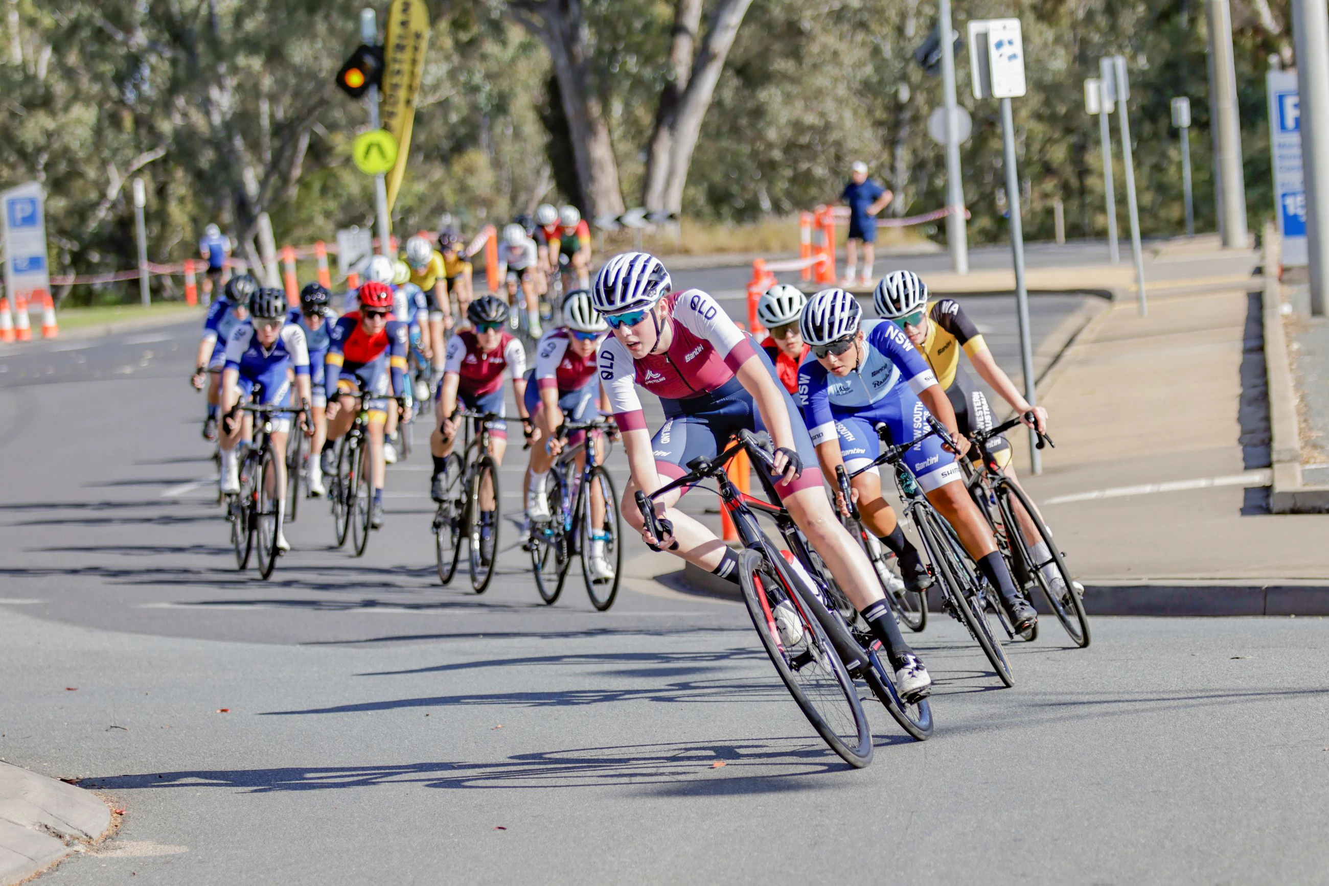A cyclist from Queensland leads the peloton in the under-17 women's criterium national championship in Shepparton, Victoria in 2023