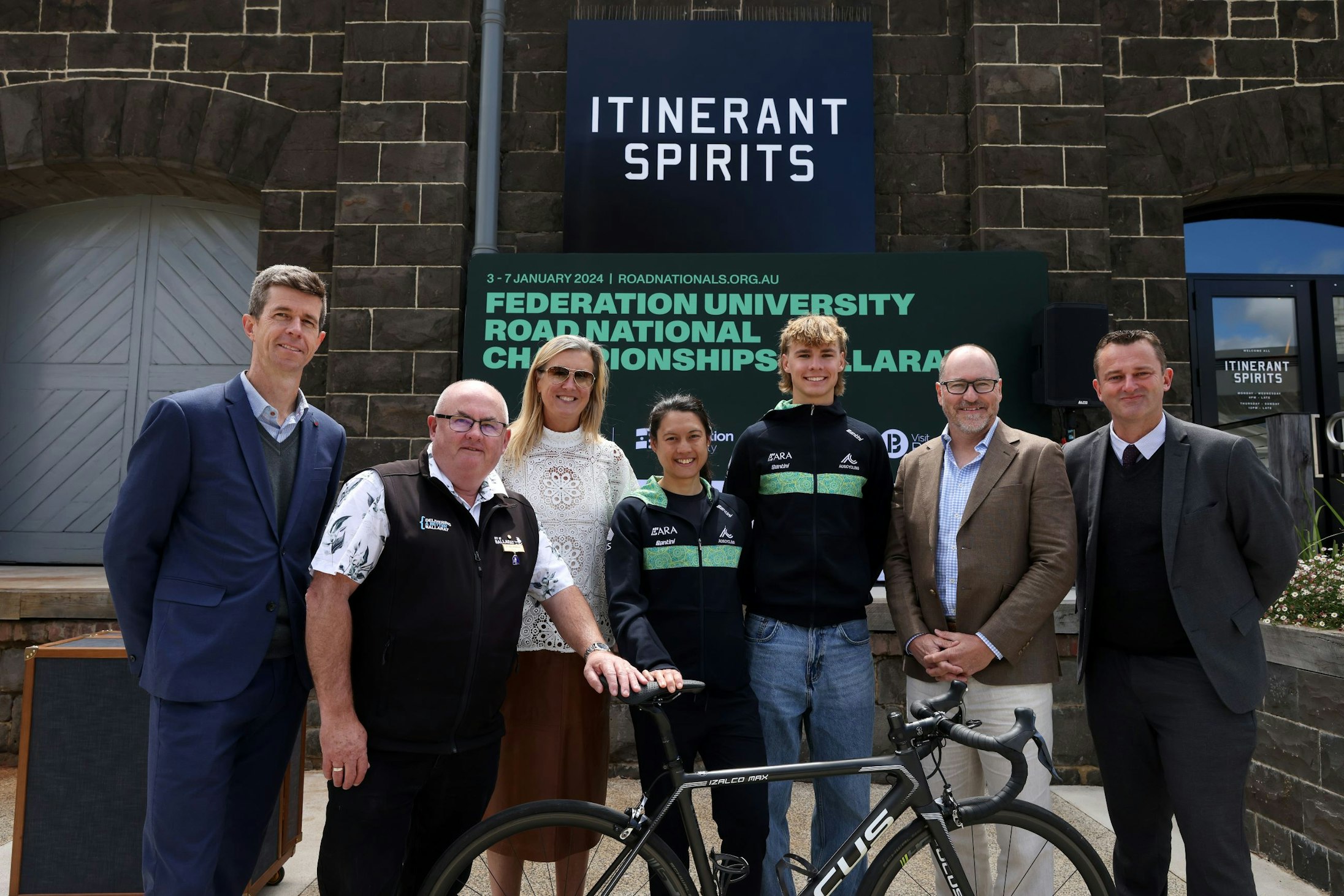 Officials and athletes pose at the 2024 Federation Unviersity Road National Championships RoadNats Ballarat media launch: Matthew Keenan, Des Hudson mayor of Ballarat, Marne Fechner CEO of AusCycling, para-cyclist Alana Forster, cyclist Oscar Chamberlain, race director Scott McGrory, Daniel Moloney from Federation University