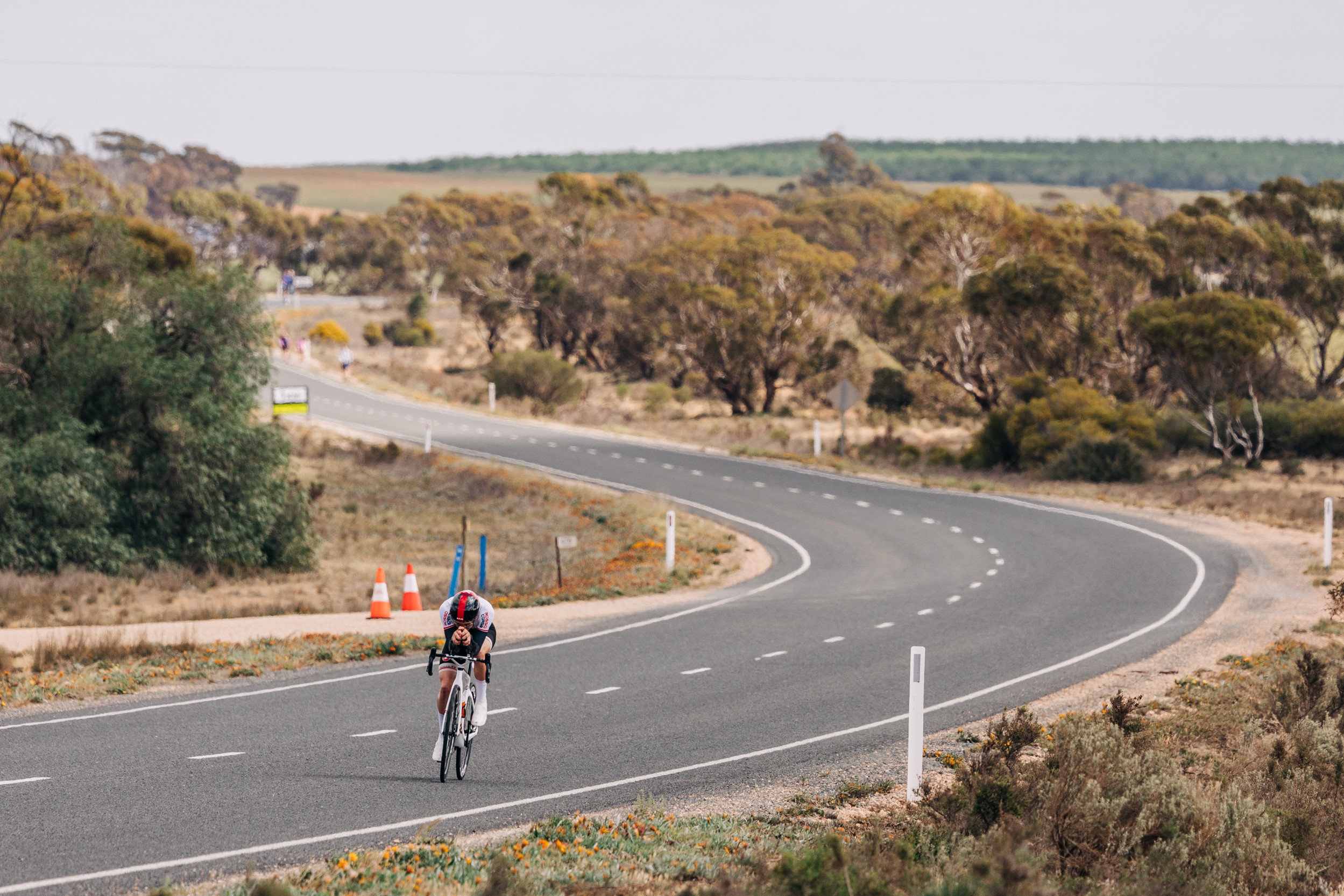 A lone cyclist cuts a lonely figure on a wide sweeping road amid the open plains of Loxton during the 2024 AusCycling Masters and Junior Road National Championships