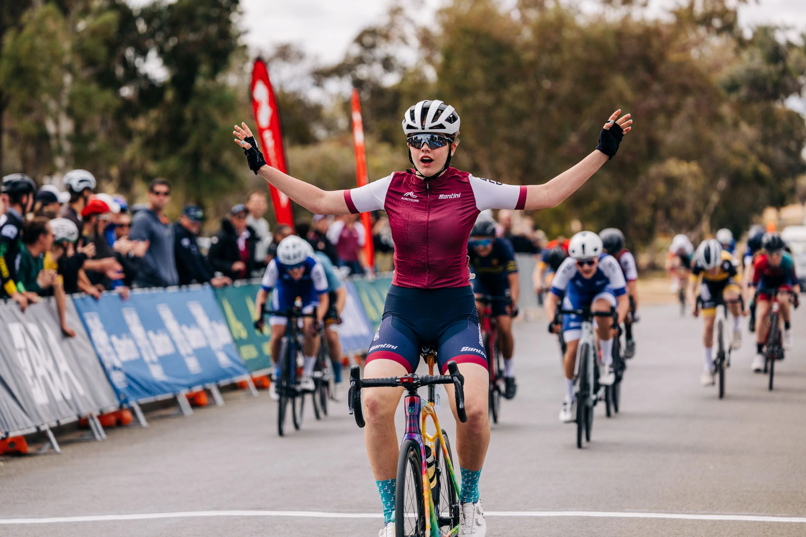 Queensland cyclist Ava Robbins celebrates across the line as she wins the sprint in the under-15 women's road race national championship at the 2024 AusCycling Masters & Junior Road National Championships in Loxton