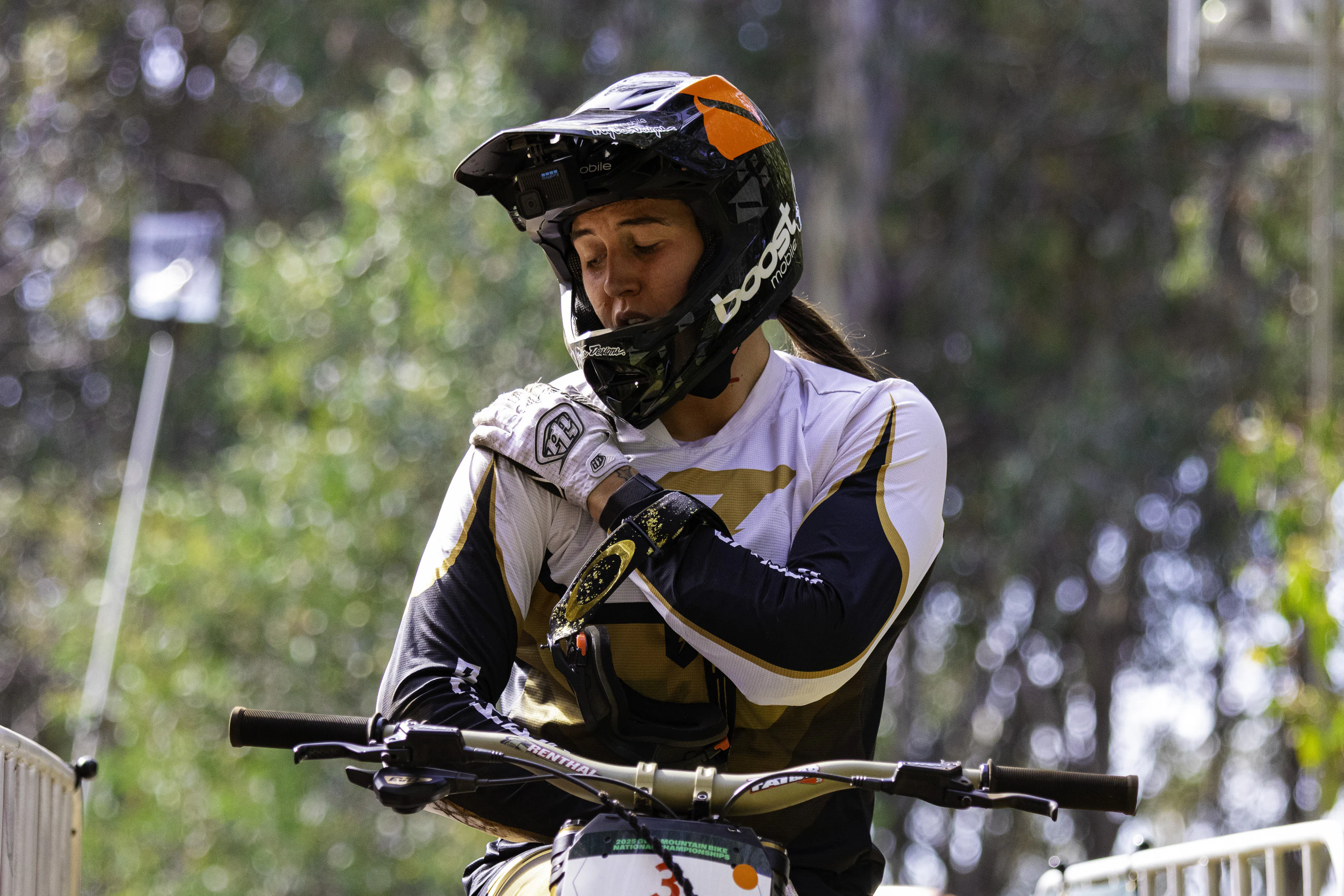 Australian downhill mountain biker Sian A'Hern clutches her right shoulder in pain after seeding in the elite women's downill at the 2025 GWM Mountain Bike National Championships at Mount Buller, Victoria. Photo by Ryan Miu / AusCycling