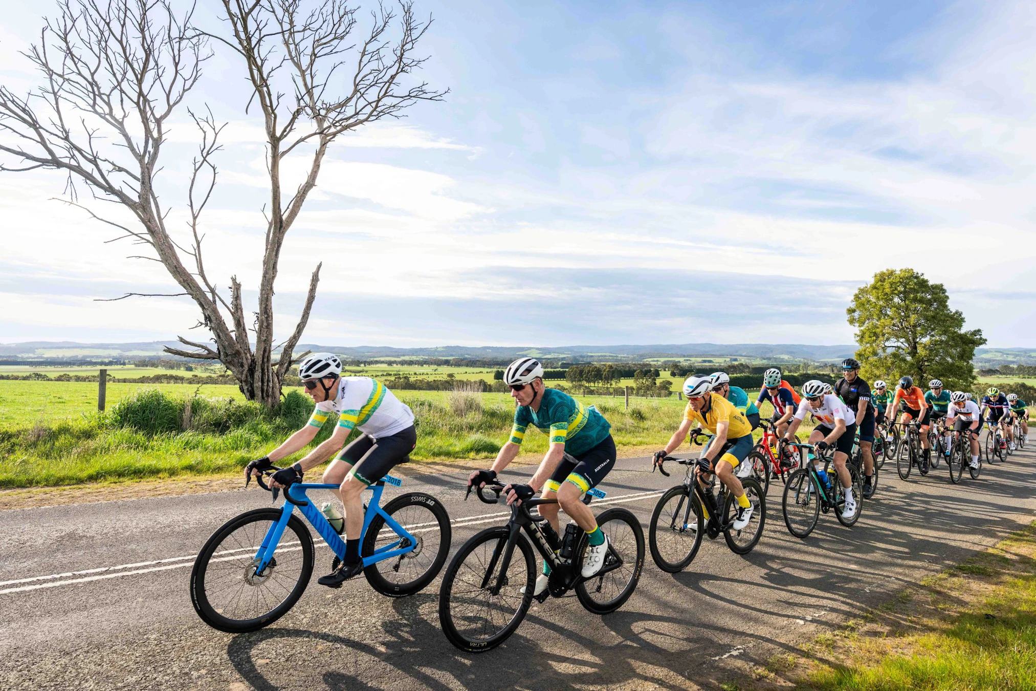 Cyclists riding together on a country road