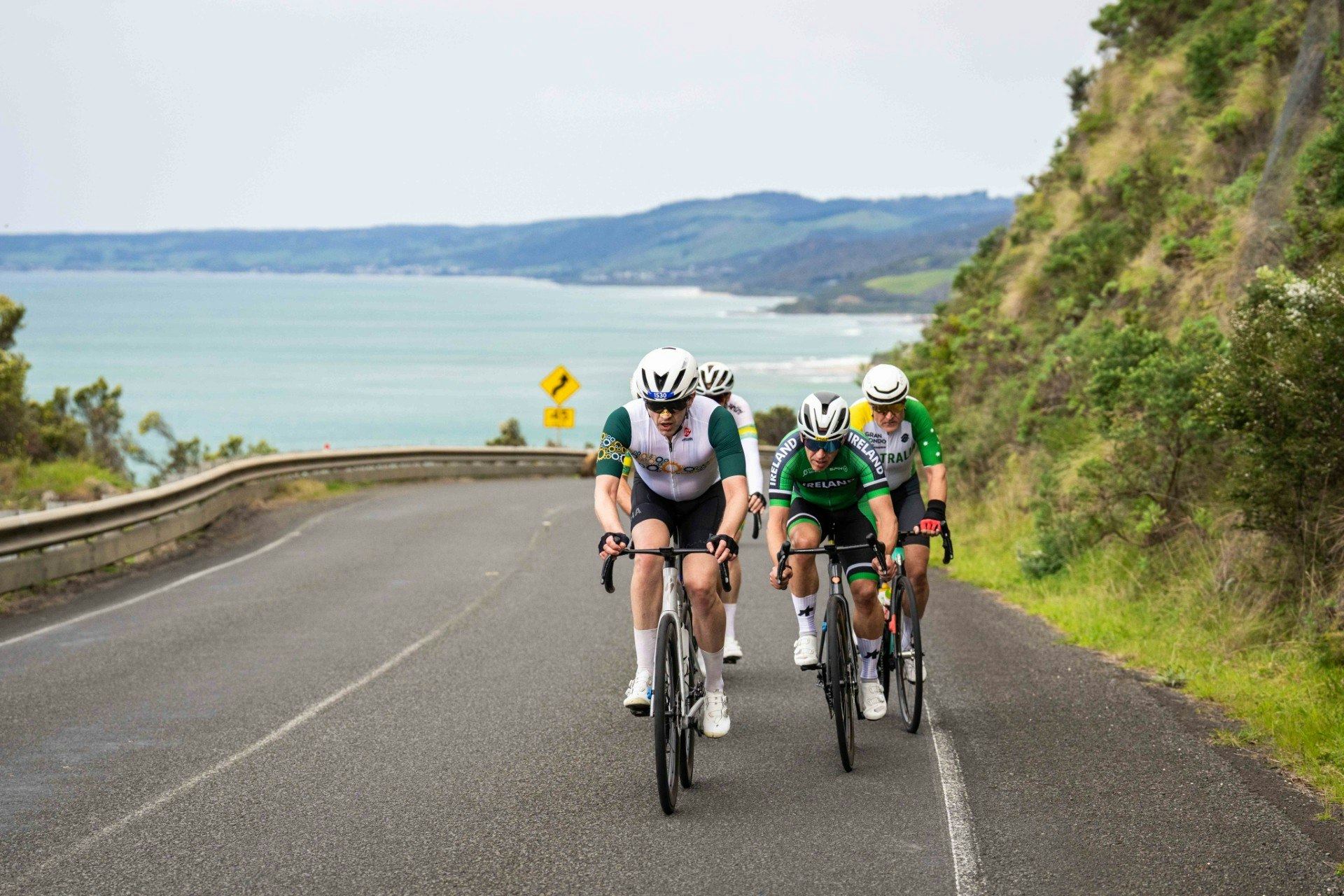 A small group of Australian and Irish cyclists during the UCI Gran Fondo World Championships gran fondo road race starting and finishing in Lorne and taking place on the Great Ocean Road, Victoria, Australia alongside Amy's Gran Fondo.