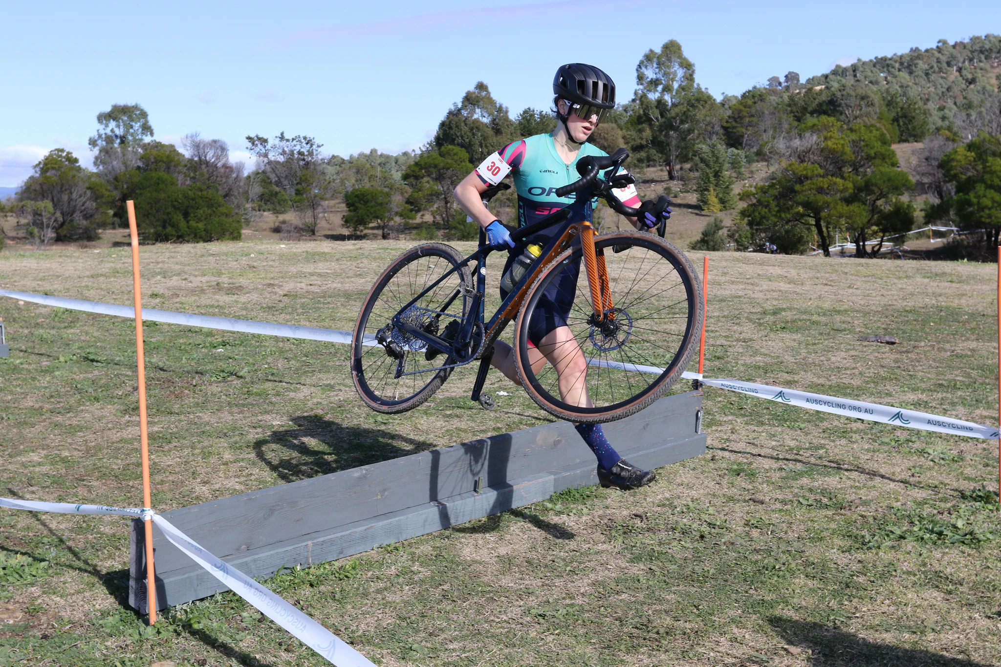 Katherine Hosking leaps the boards in Round 3 of the AusCycling Cyclo-cross National Series in Canberra