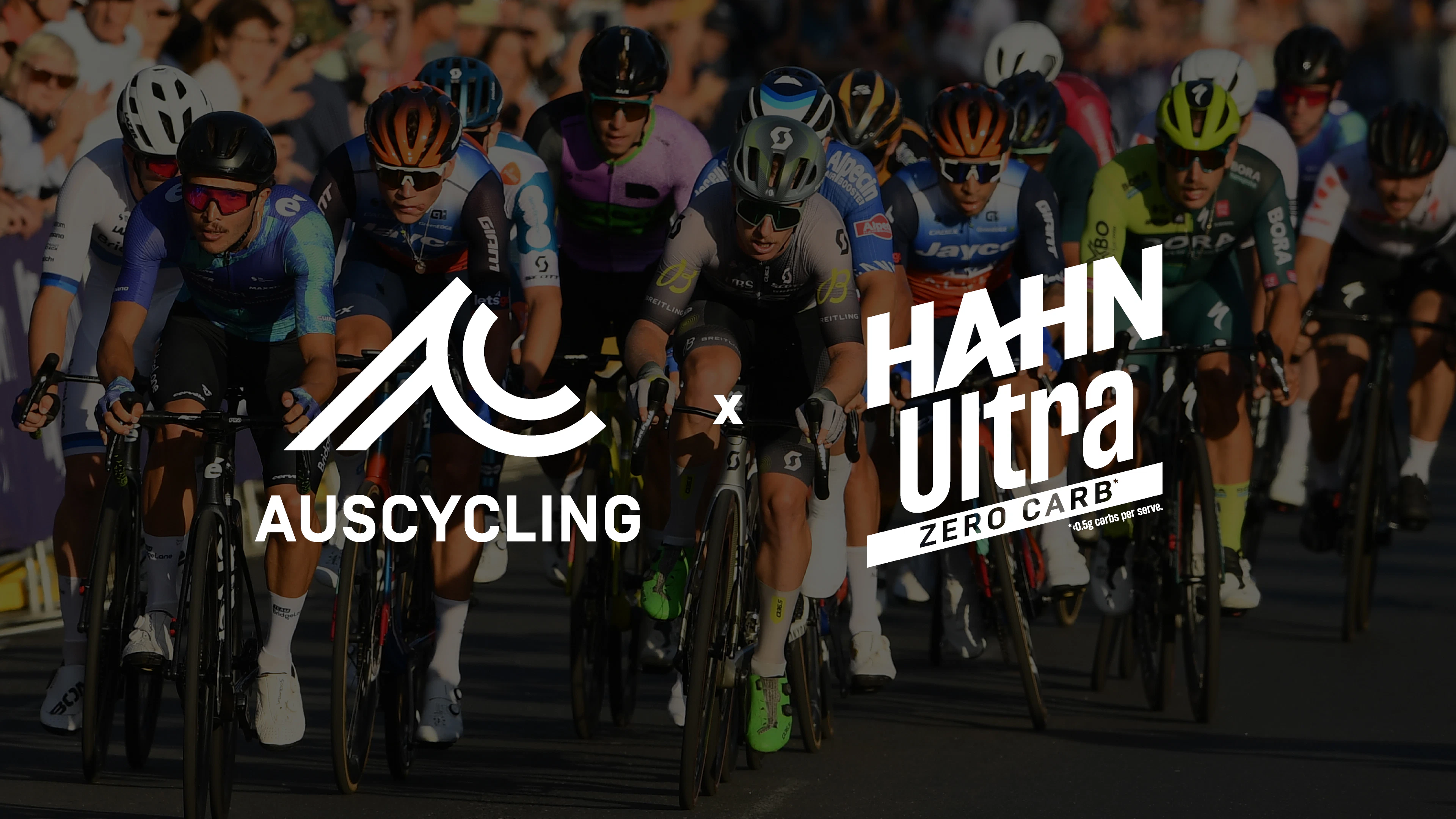 AusCycling logo and Hahn Ulta Zero Carb logos overlaid on a peloton of racing road cyclists