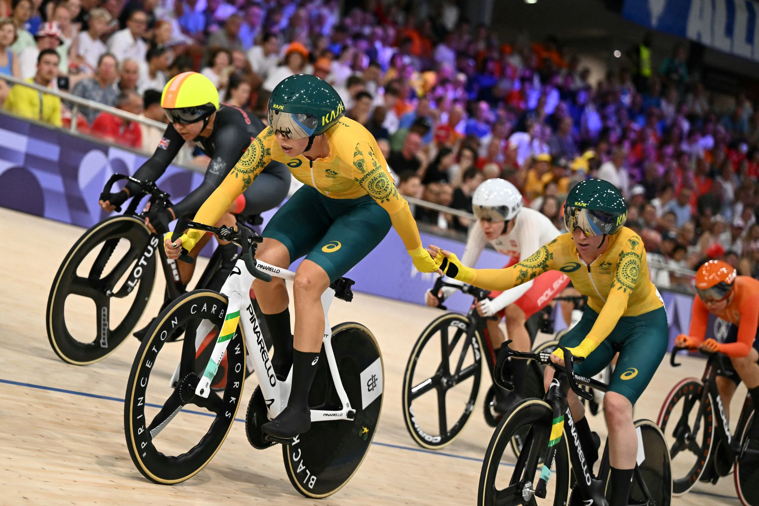 Australia's Georgia Baker relays Australia's Alexandra Manly as they compete in the women's track cycling Madison final of the Paris 2024 Olympic Games at the Saint-Quentin-en-Yvelines National Velodrome in Montigny-le-Bretonneux, south-west of Paris, on August 9, 2024. 