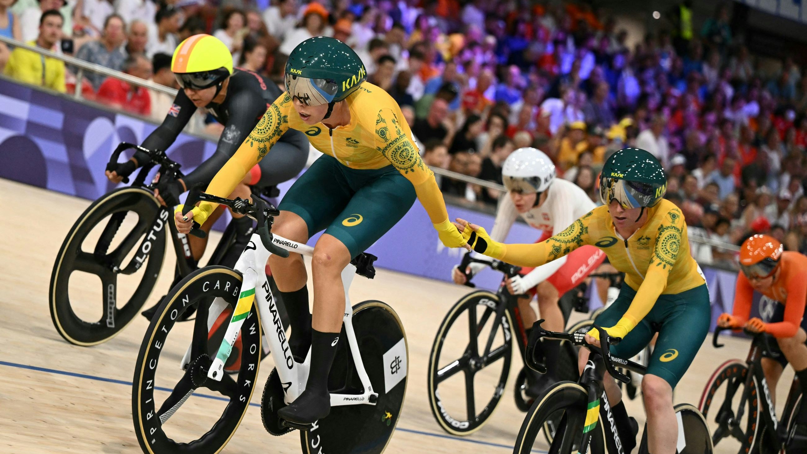 Australia's Georgia Baker relays Australia's Alexandra Manly as they compete in the women's track cycling Madison final of the Paris 2024 Olympic Games at the Saint-Quentin-en-Yvelines National Velodrome in Montigny-le-Bretonneux, south-west of Paris, on August 9, 2024.