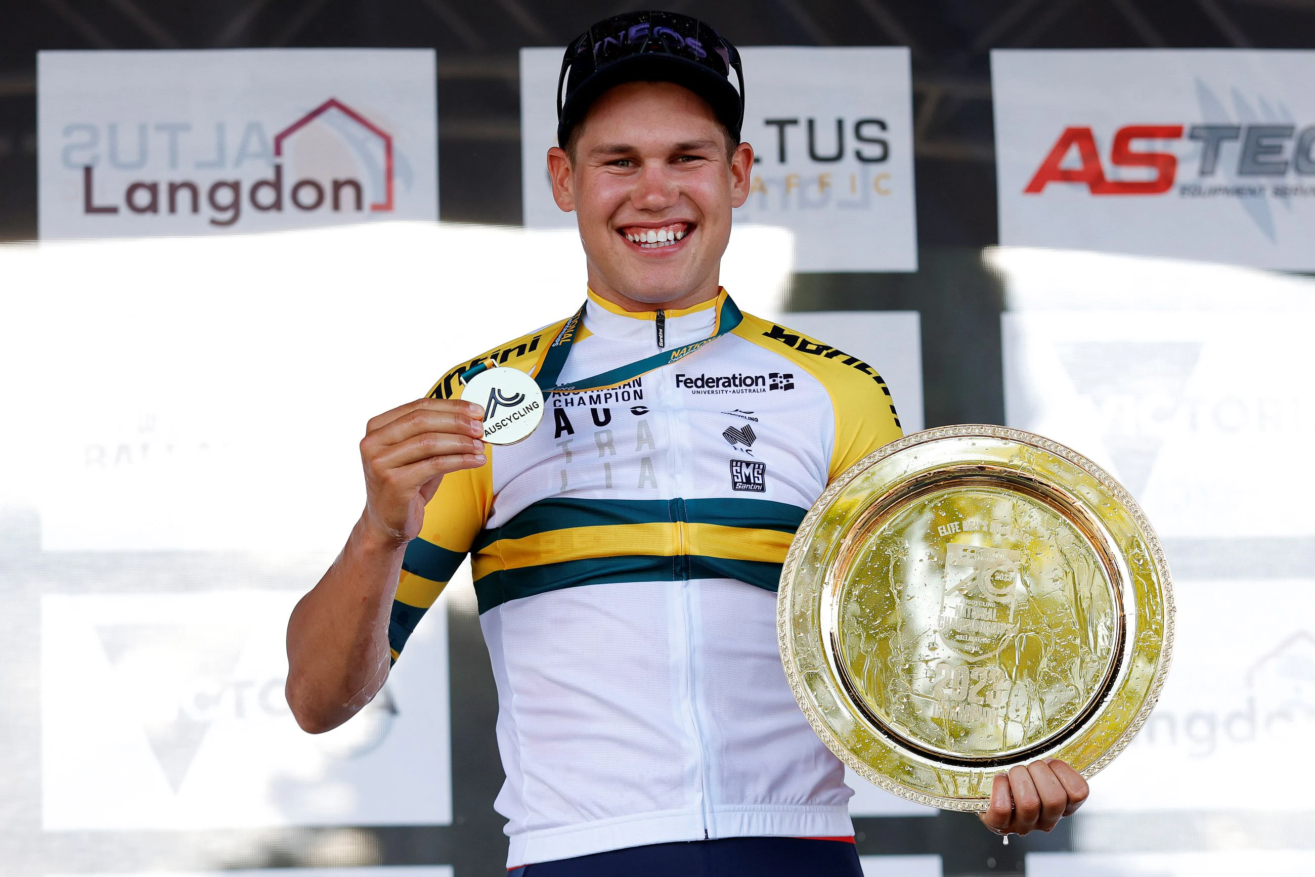 Lucas Plapp poses with medal, gold plate and green-and-gold jersey as the 2023 elite men's road race national champion at the Road National Championships RoadNats Ballarat