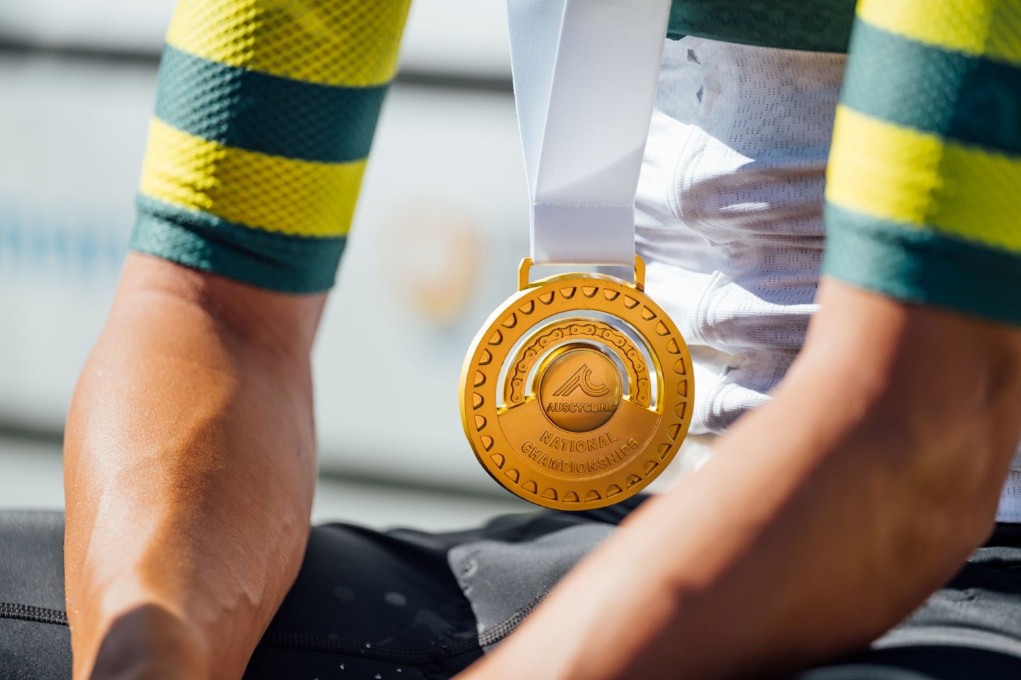 The National Champion gold medal worn by someone in the green-and-gold jersey