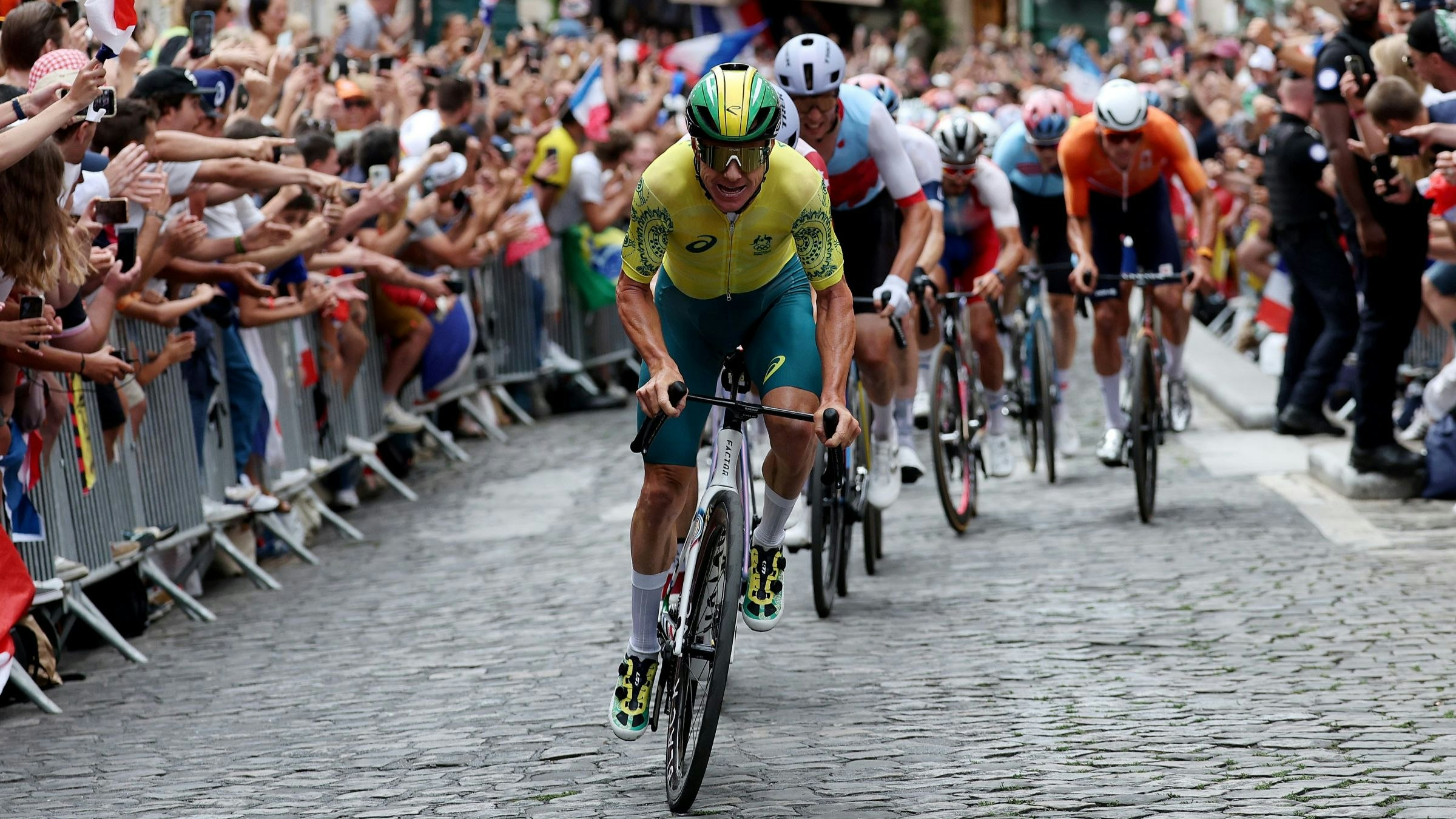 Australian road cyclist Simon Clarke attacks the cobbled climb during the Paris 2024 Olympic Games