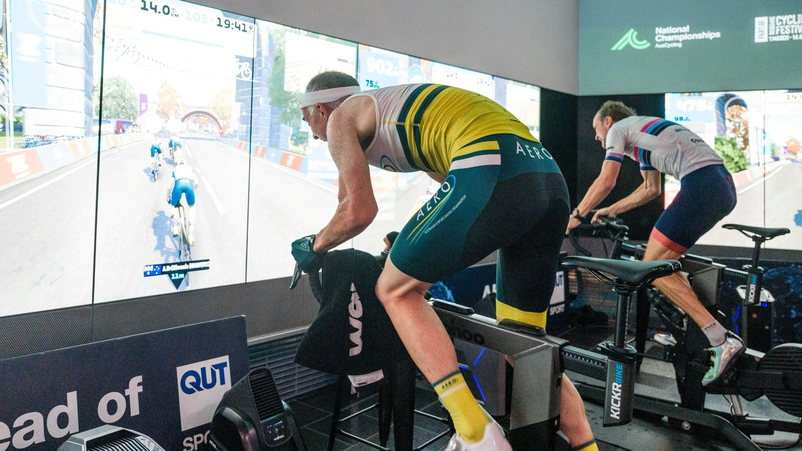 Cyclists in action at the 2024 AusCycling Esports National Championships at the QUT's The Cube in Brisbane
