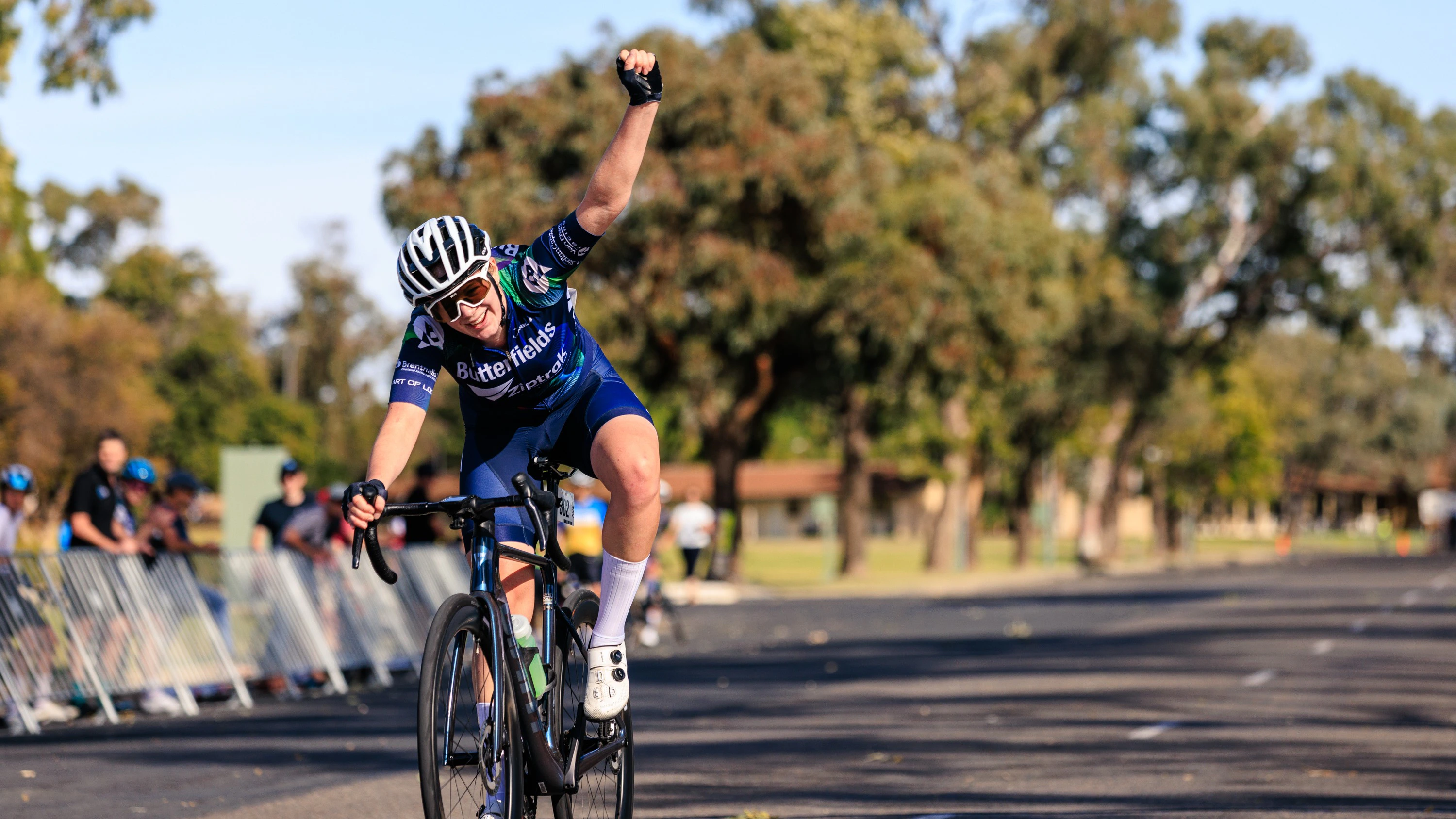 Ava Schmidtke of Butterfields ZipTrack Racing and South Coast Cycling Club salutes as she wins stage three of the 2025 Junior Tour of the Riverland, part of the BikeChain J19 National Road Series
