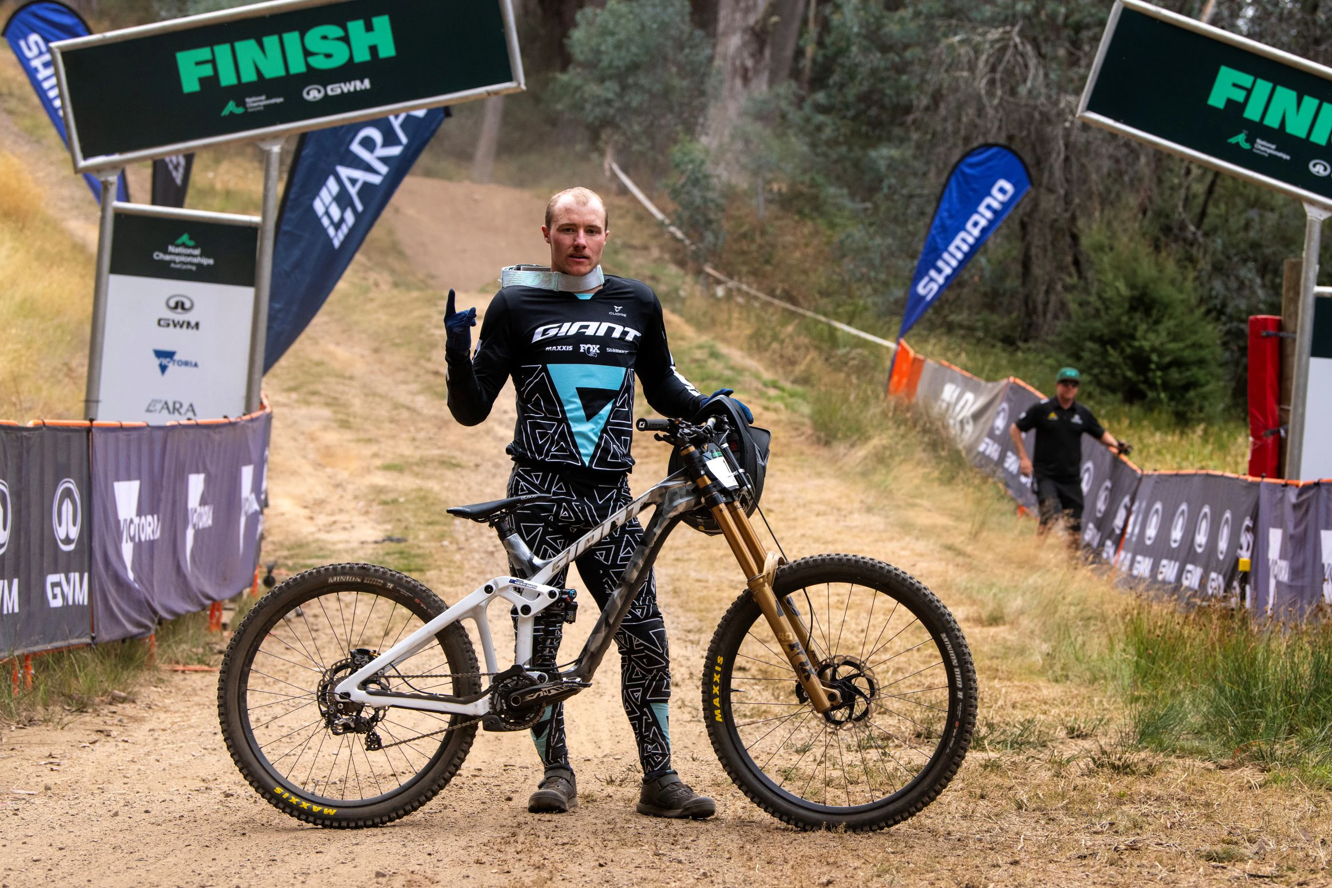Australian downhill mountain biker Luke Meier-Smith poses with his Giant bicycle at the finish line after winning the elite men's downhill at the 2025 GWM Mountain Bike National Championships at Mount Buller. Photo by Matt Rousu