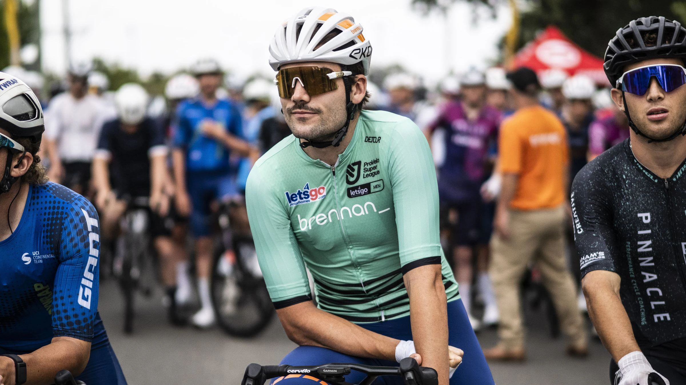 Conor Leahy in the green ProVelo Super League (PSL) leader's jersey at the start line of a road race
