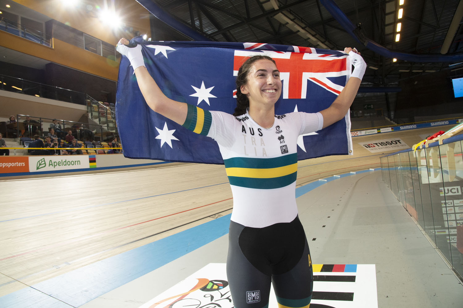 Paige Greco celebrates with the Australian flag after winning at the 2019 UCI Para-cycling Track World Championships