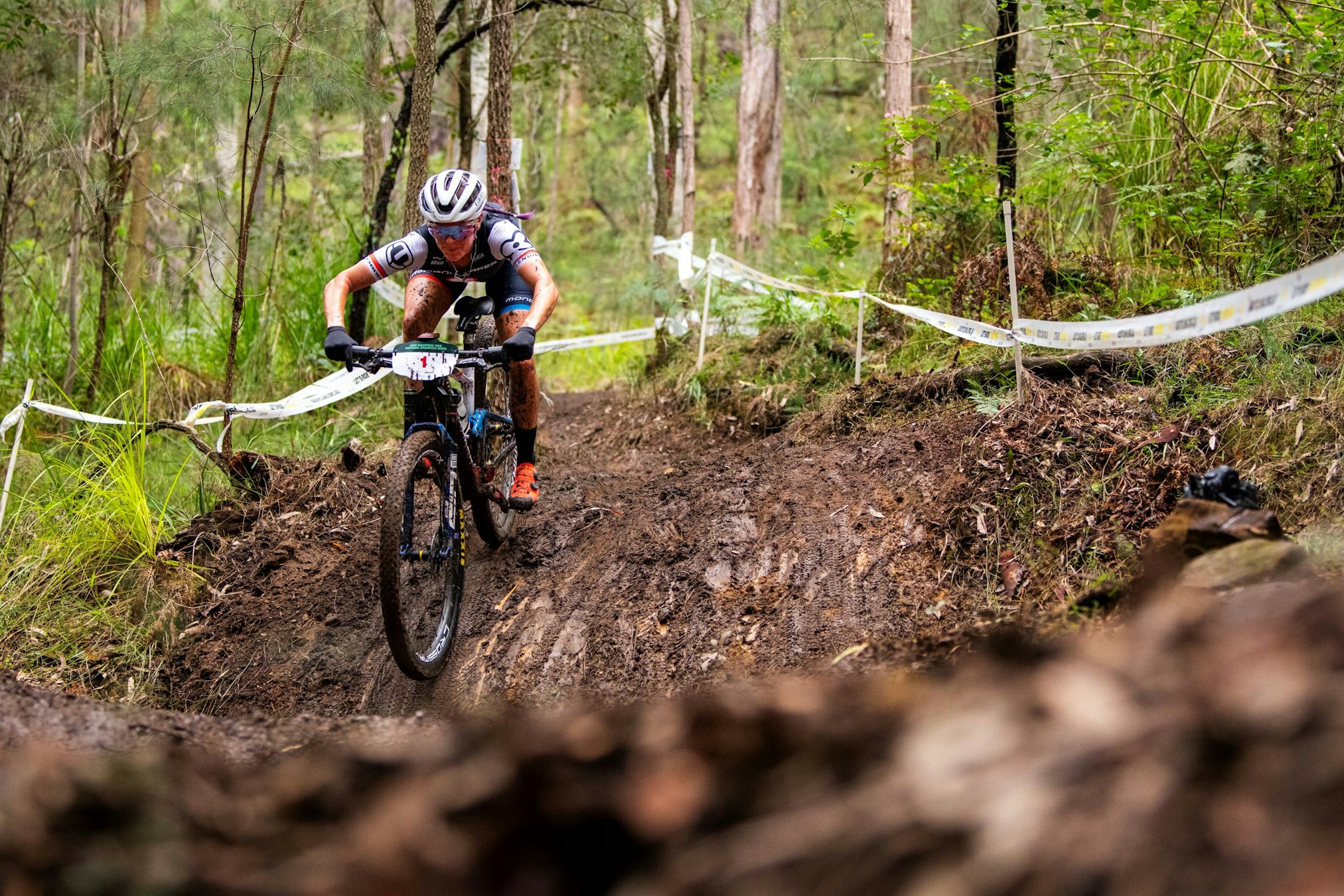 Australian mountain bike rider Rebecca Henderson negotiates a muddy section of track at the 2024 GWM Mountain Bike National Championships in Awaba