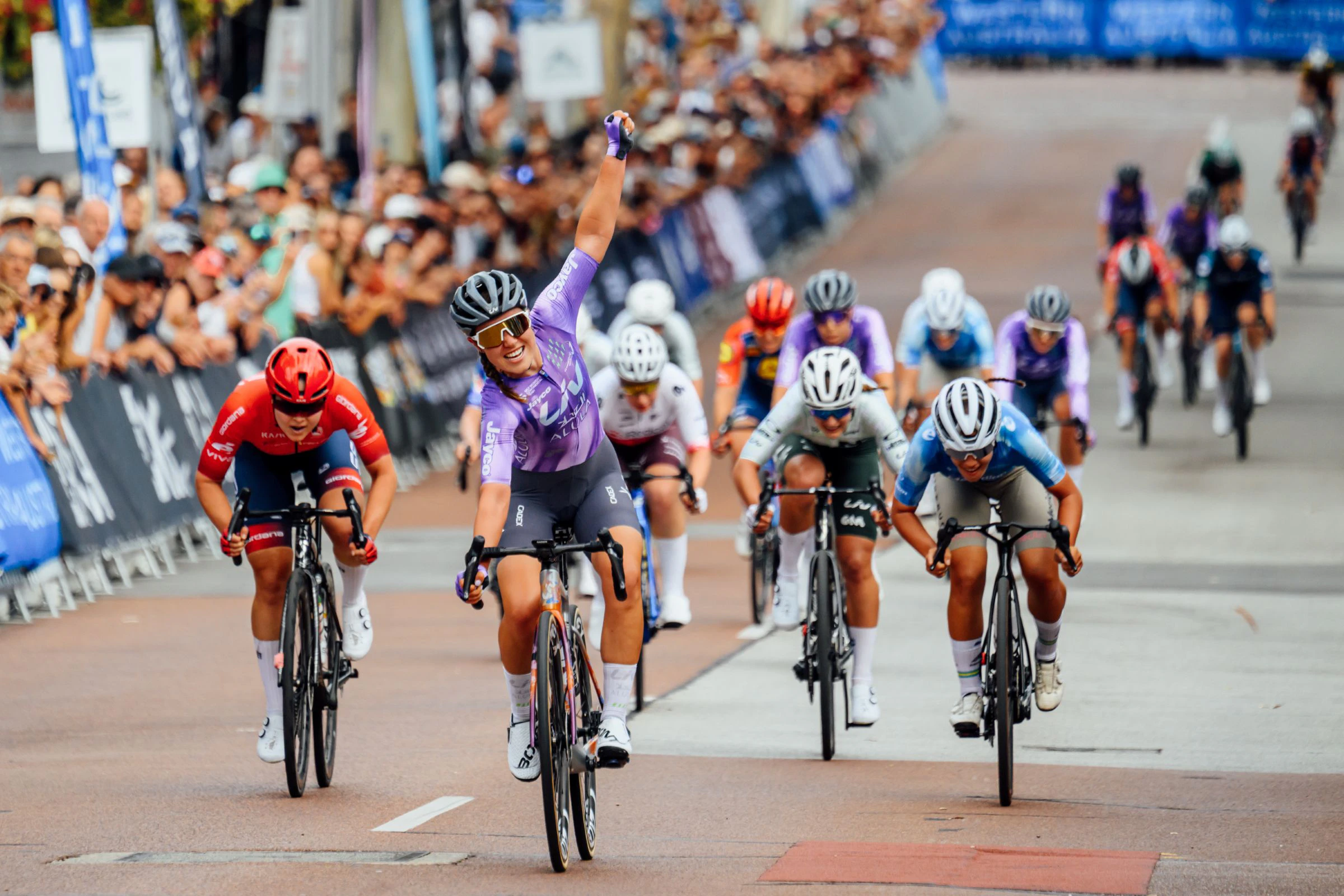 Lucinda Stewart salutes in victory in the under-23 women's criterium in the 2026 Westbridge Funds Road National Championships in Perth, Western Australia
