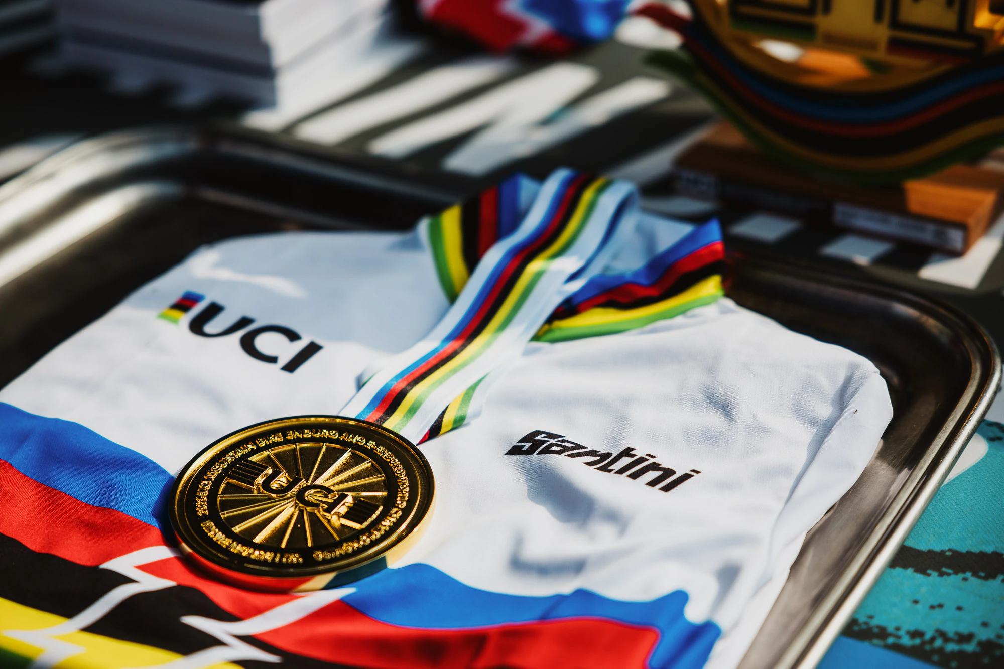 A close-up of a UCI World Champion's rainbow jersey and gold medal from the 2026 UCI Enduro World Championships (Nicola Damonte)
