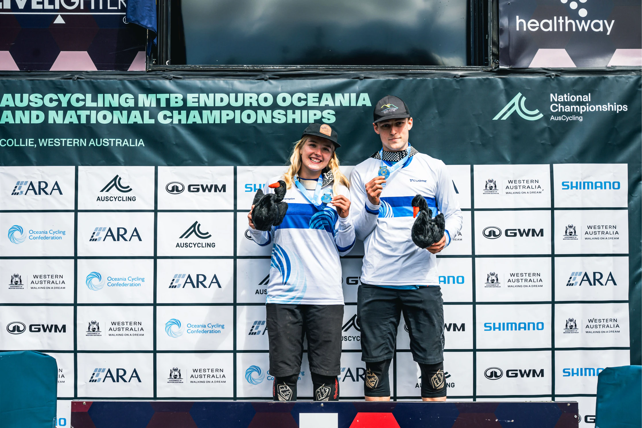 Connor Mielke (left) and Archie Winter (right) celebrate winning the 2026 AusCycling MTB Oceania Elite Women's and Men's Championships. Picture: Dan Hoey (BrokenPhotography)
