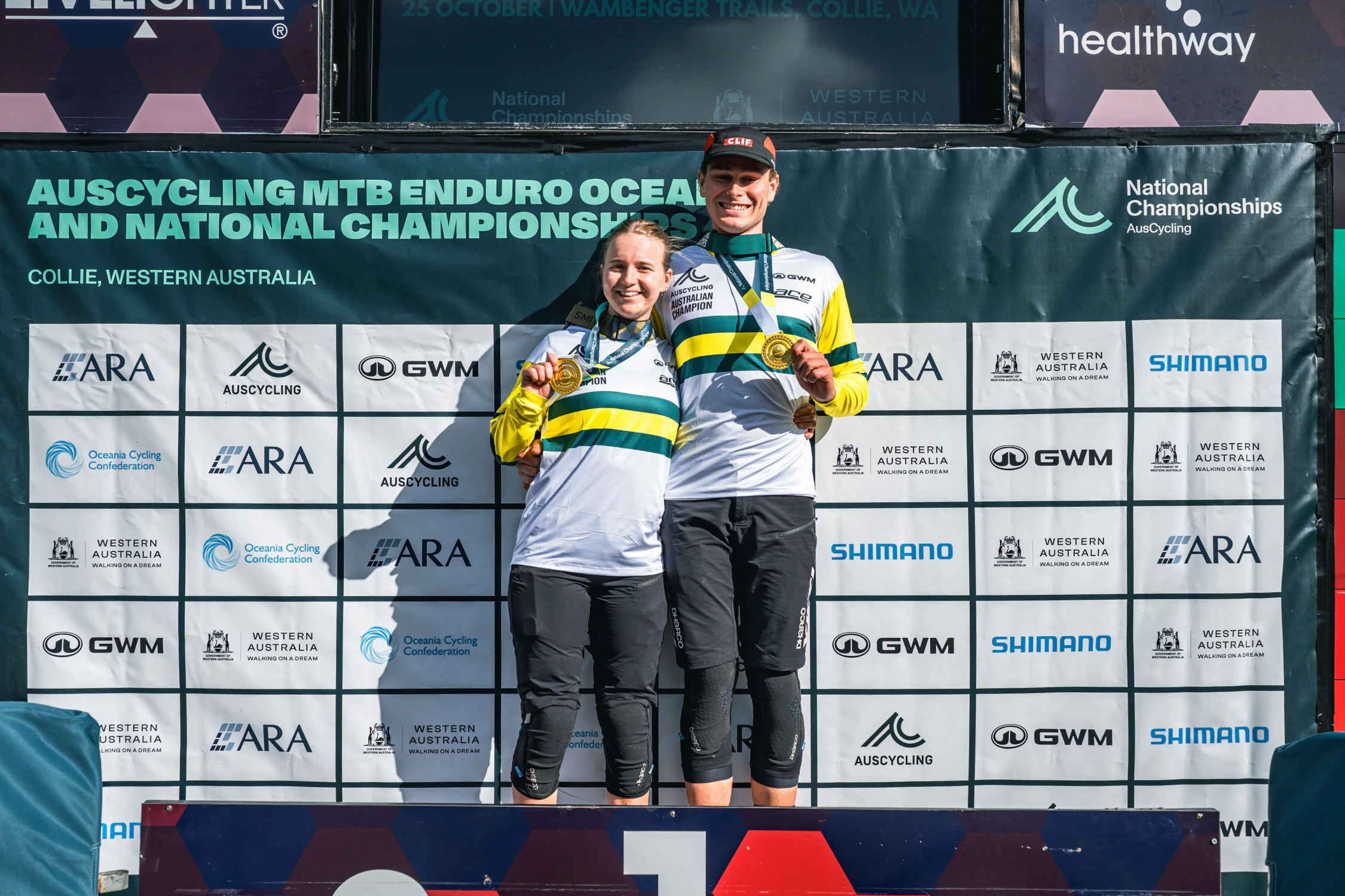 Zana Evans (left) and Tom Locke (right) celebrate winning the 2026 AusCycling MTB National Elite Women's and Men's Championships. Picture: Dan Hoey (BrokenPhotography)