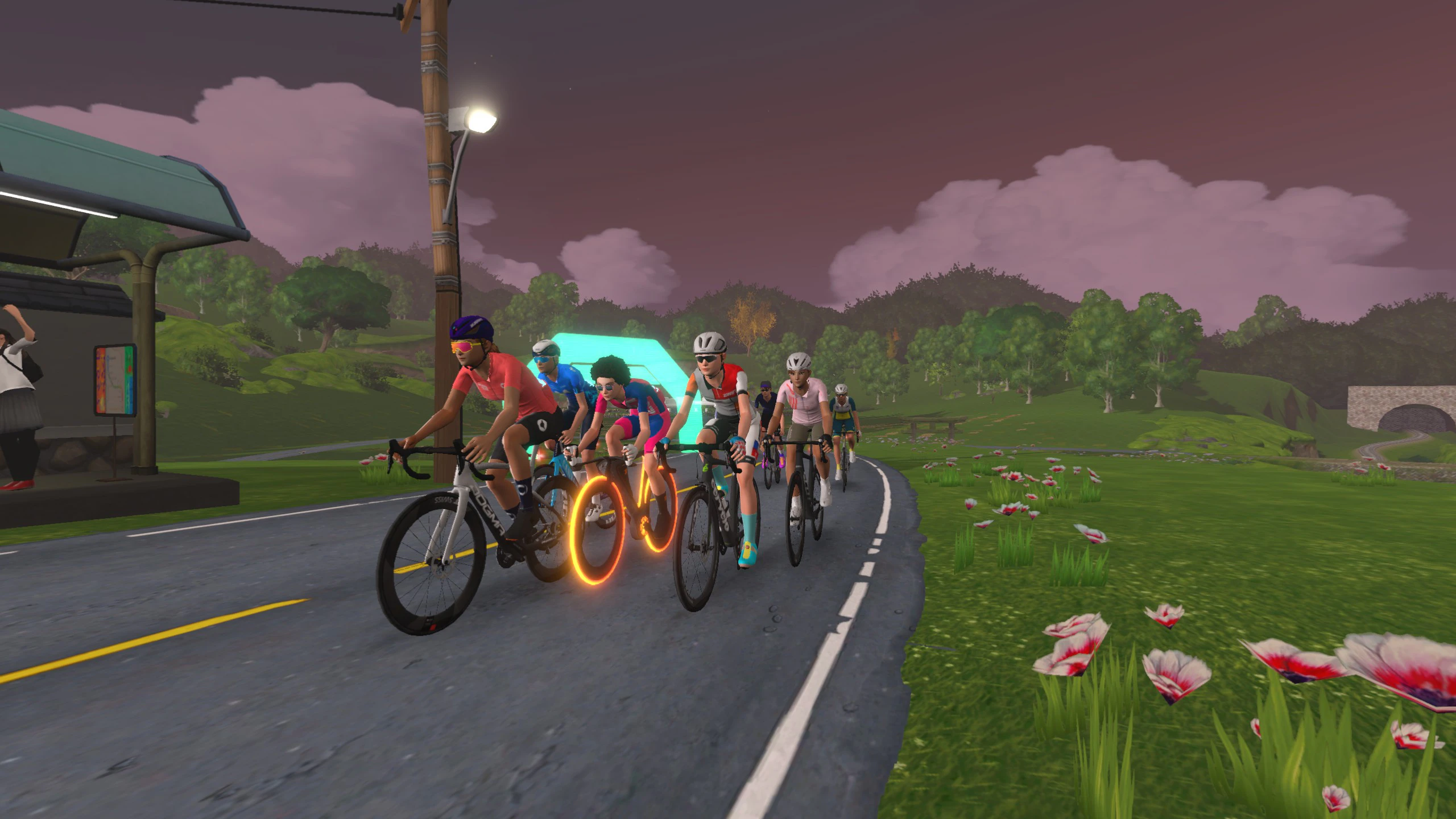 A group of female cycling avatars in Zwift's Makuri Island's map at dusk