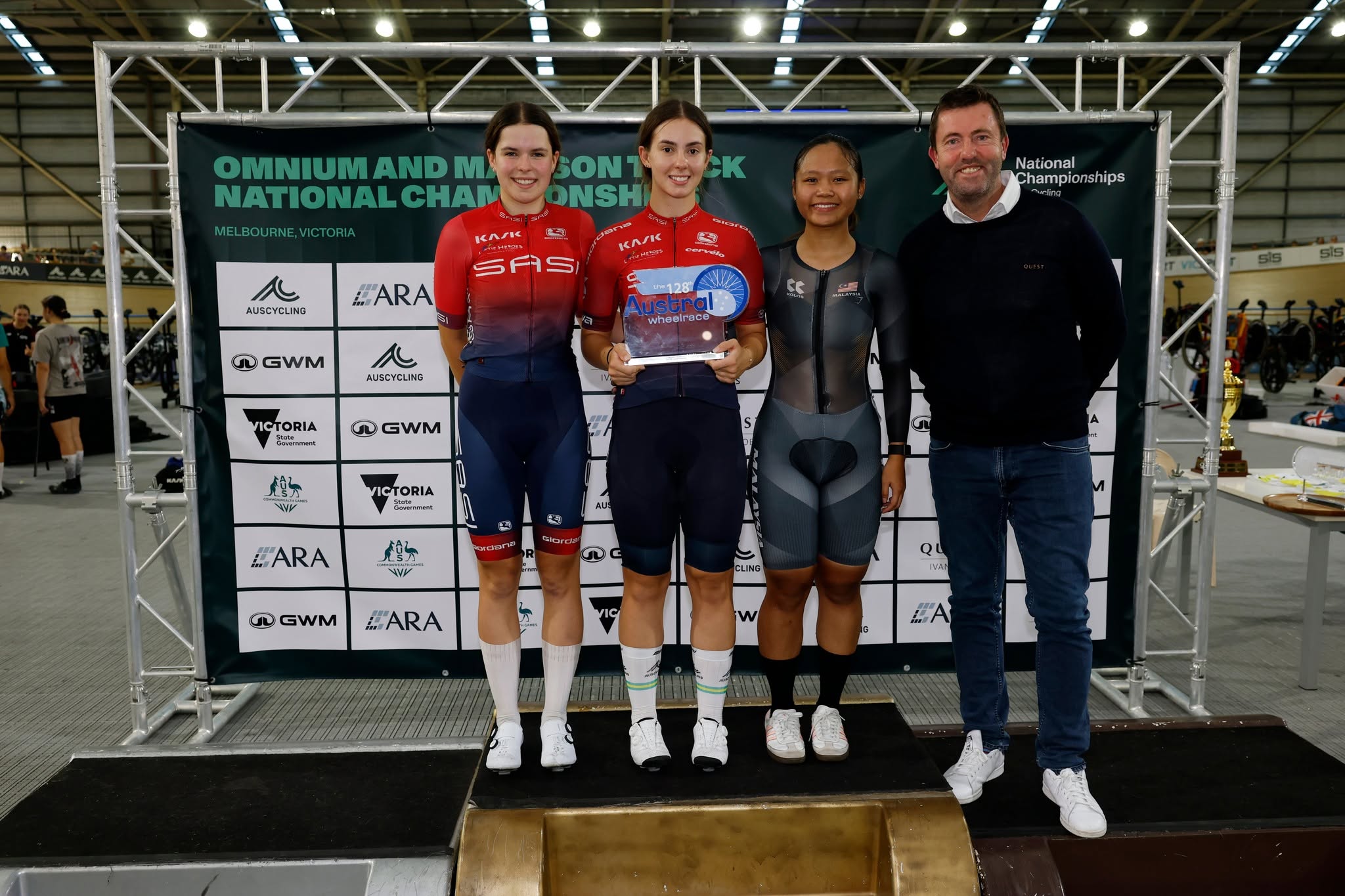 Quest Ivanhoe Women's Austral Wheelrace (128th event) podium (1. Leani van der Berg, 2. Maddie Wasserbaech, 3. Nur Alyssa MOHD FARID) with Quest Ivanhoe franchisee. Picture: Con Chronis