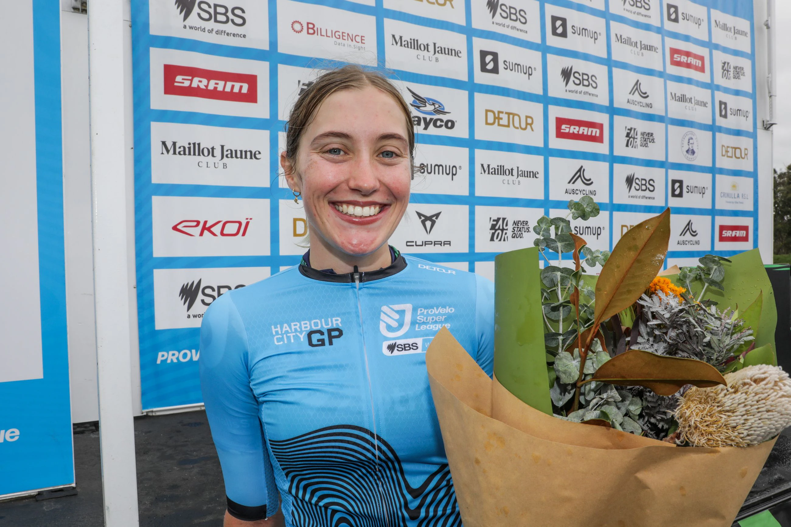 Alli Anderson of Butterfields Ziptrak Racing poses in the blue jersey of the general classification overall winner of the women's Harbour City GP, part of the ProVelo Super League (PSL)