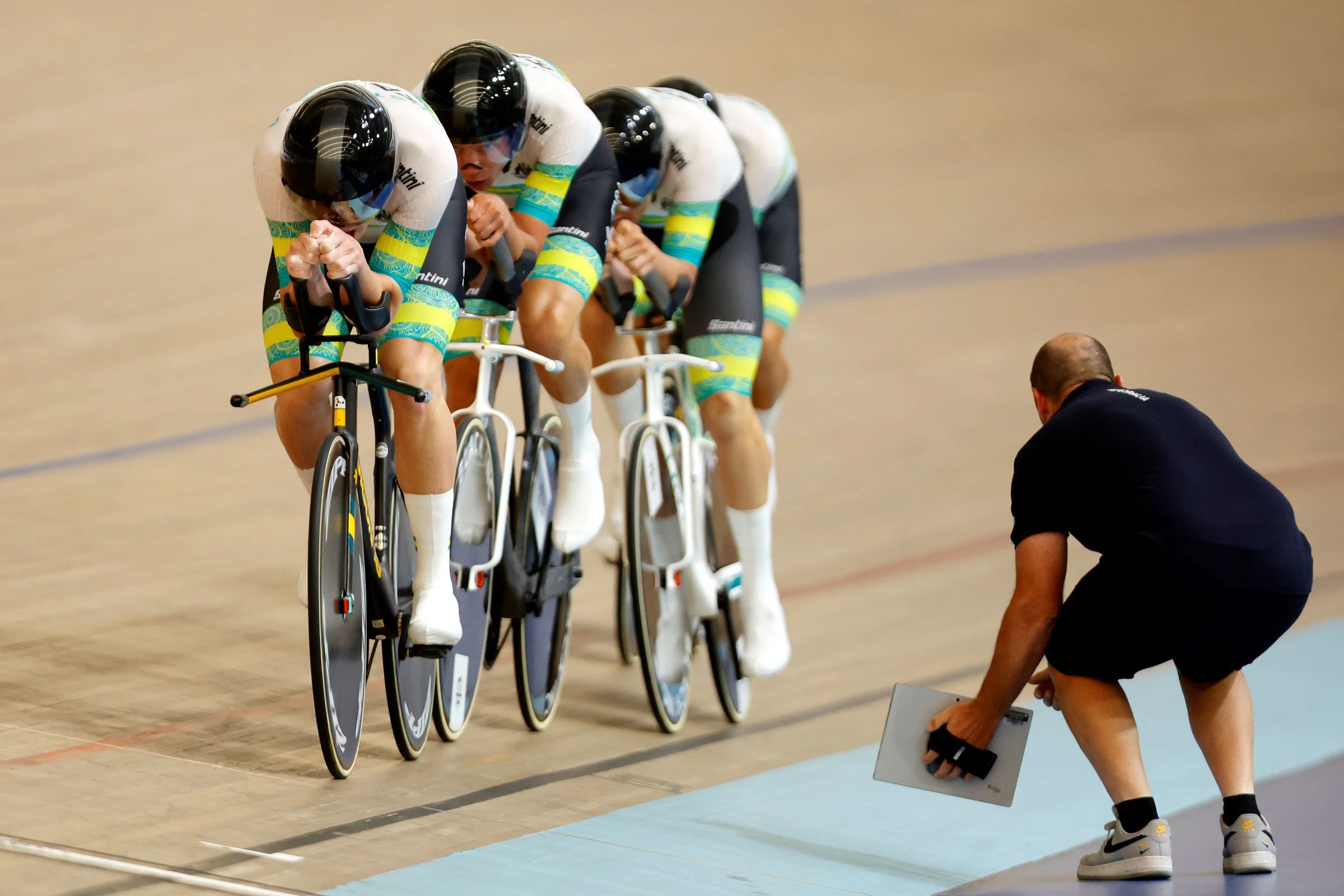 ARA Australian Cycling Team men's team pursuit racing at the 2024 UCI Track Nations Cup in Adelaide while Tim Decker holds the splits tablet. Picture: Con Chronis.