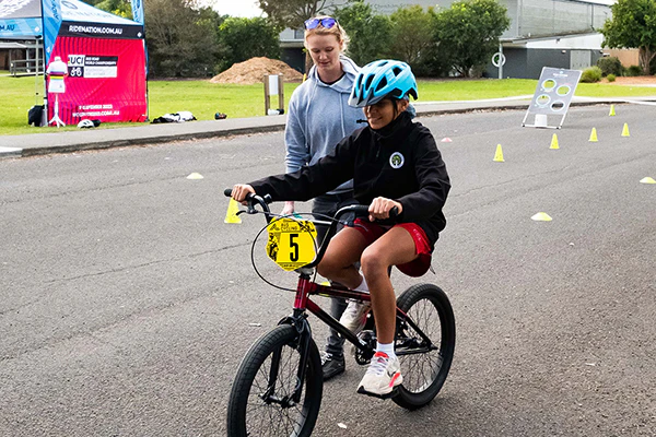 AusBike school student riding through road course