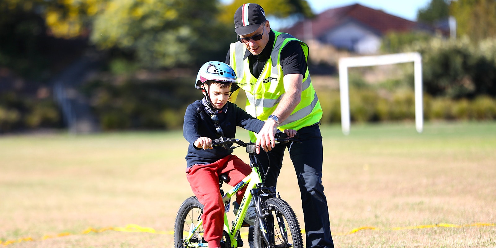 AusBike instructor helping student control bike