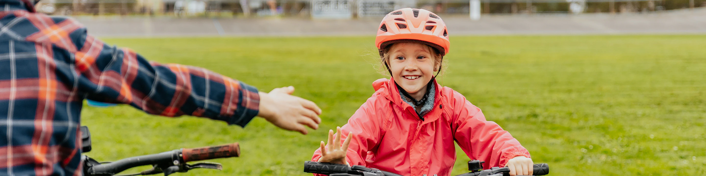 AusBike students giving high five while riding