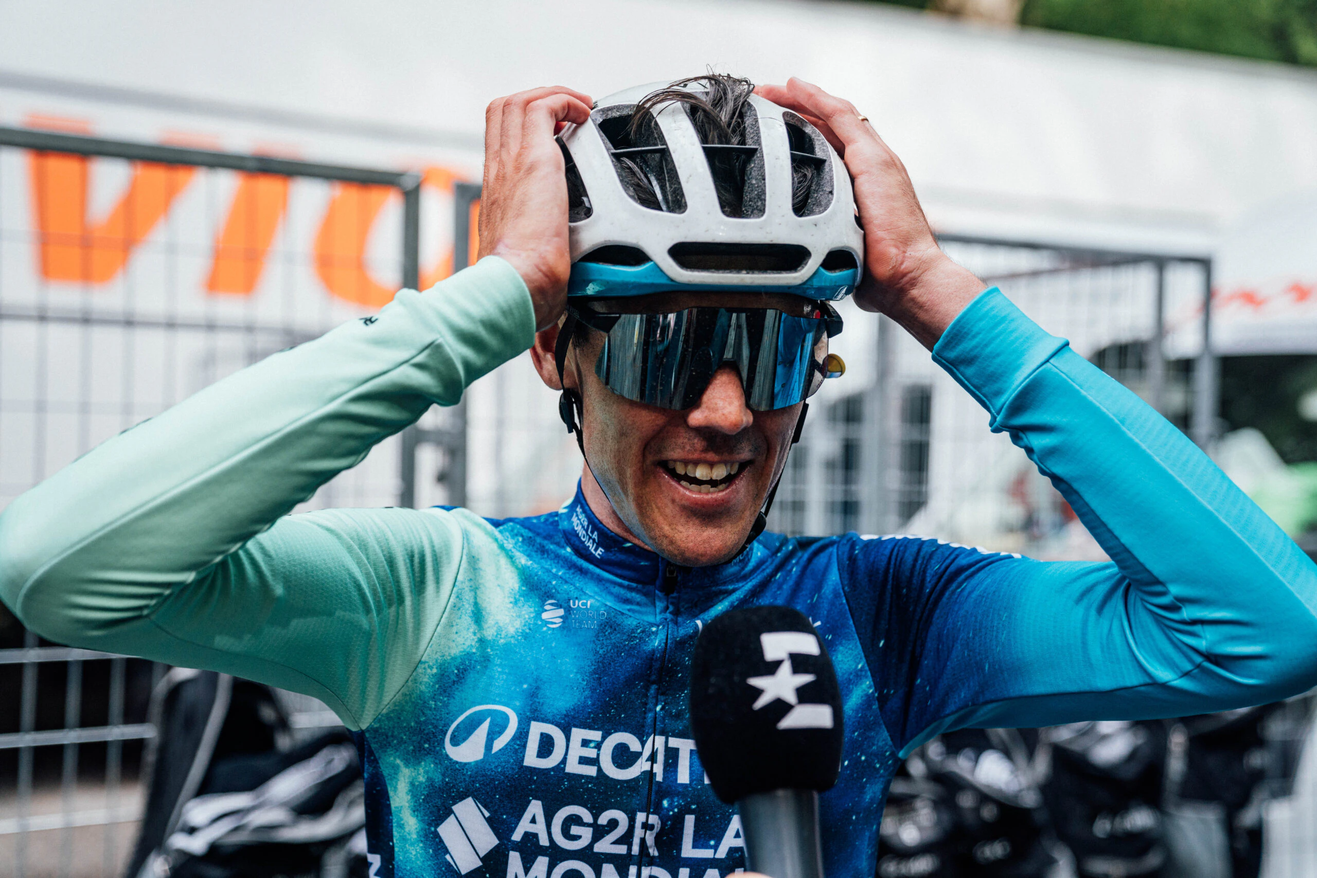 Australian cyclist Ben O'Connor, rider for Decathlon AG2R La Mondiale Team, puts his hands on his helmet as he is interviewed by television during the 2024 Giro d'Italia. Picture: Giro d'Italia