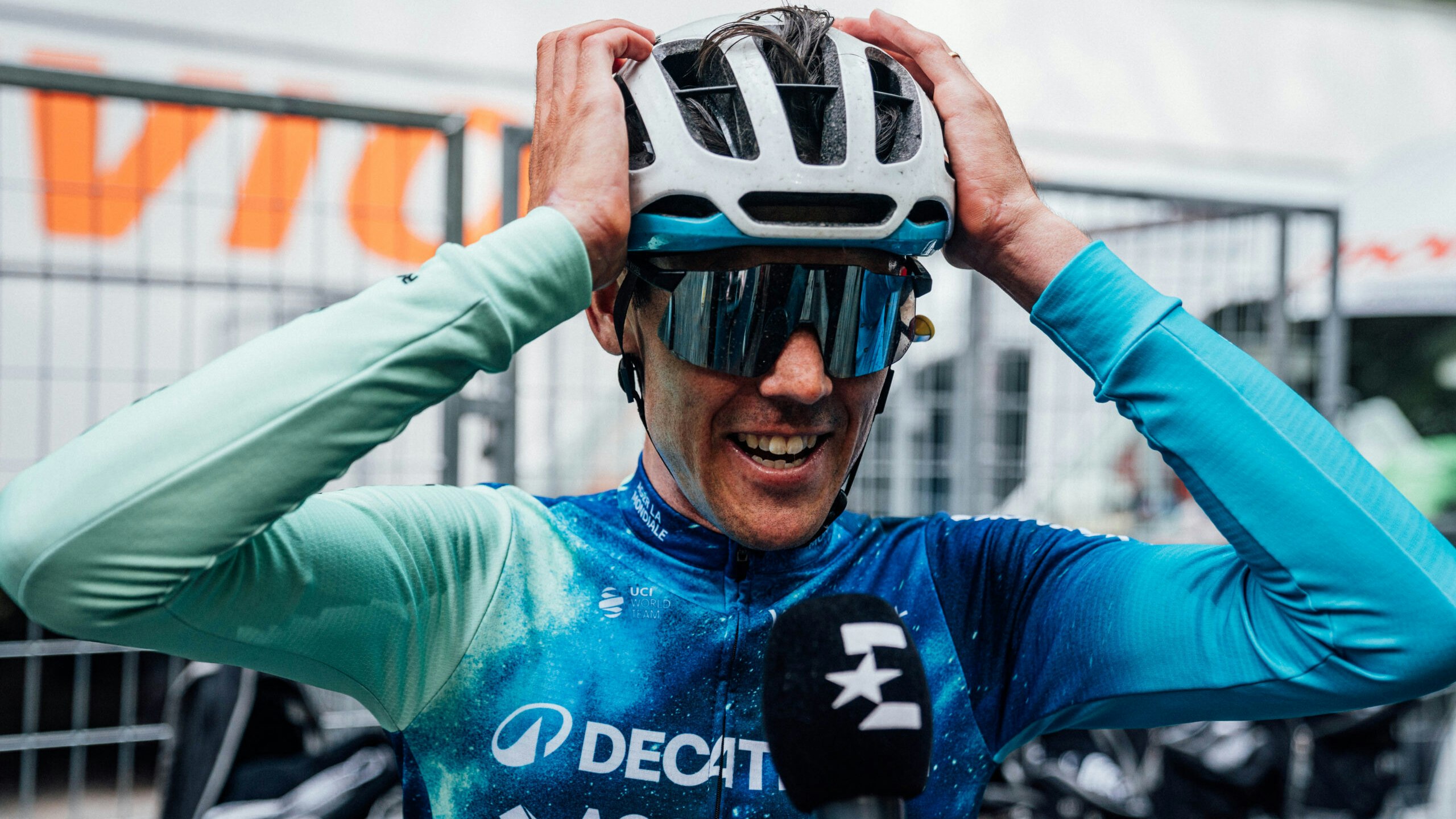 Australian cyclist Ben O'Connor, rider for Decathlon AG2R La Mondiale Team, puts his hands on his helmet as he is interviewed by television during the 2024 Giro d'Italia. Picture: Giro d'Italia