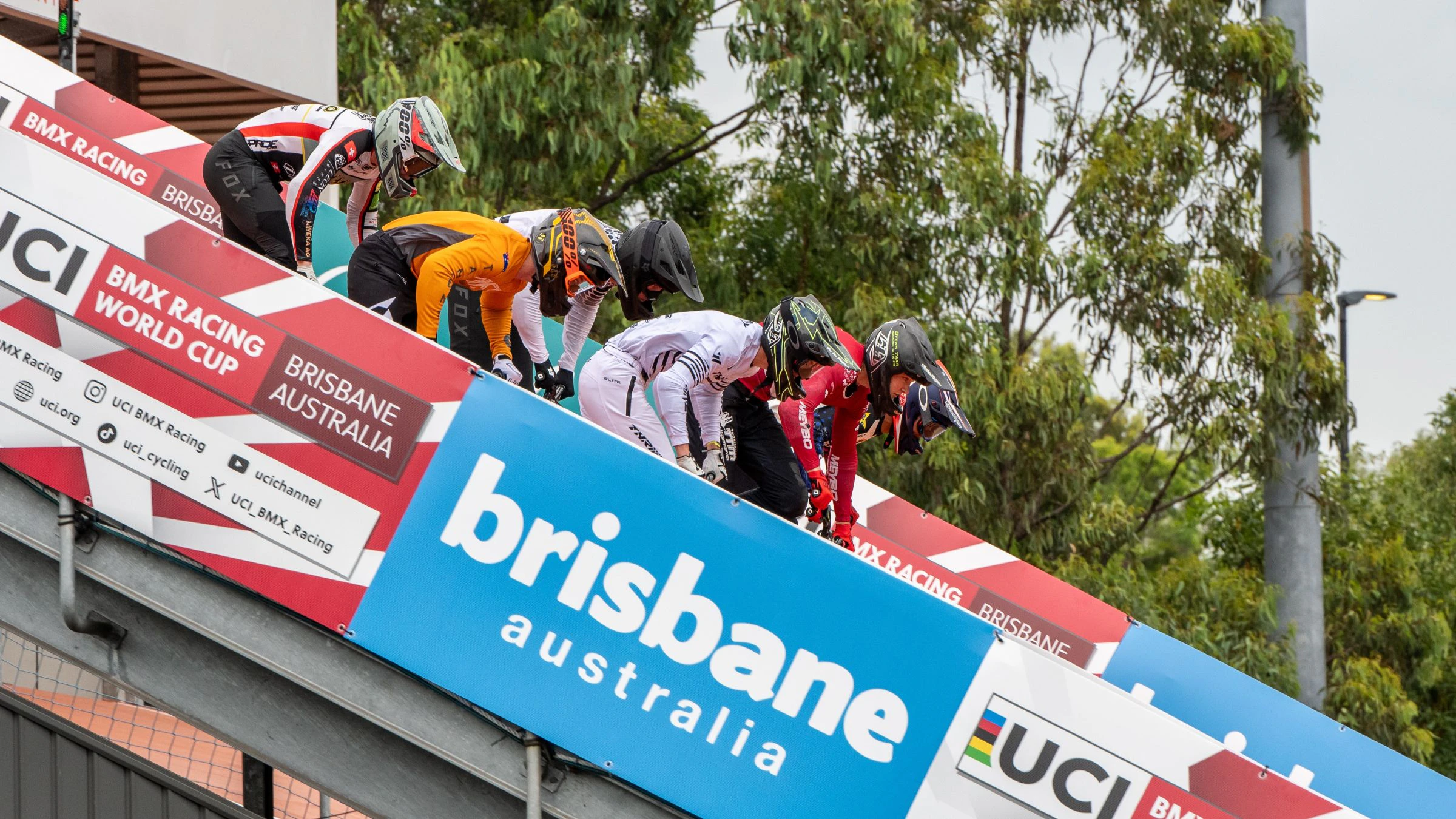 BMX Racing athletes launch down the start ramp of the Brisbane SX International BMX Centre during a UCI BMX Racing World Cup in 2024.