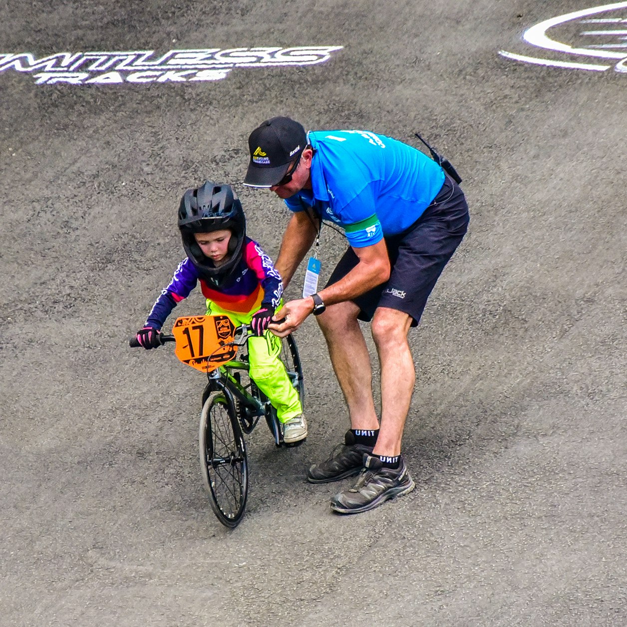 BMX commissaire assisting young rider
