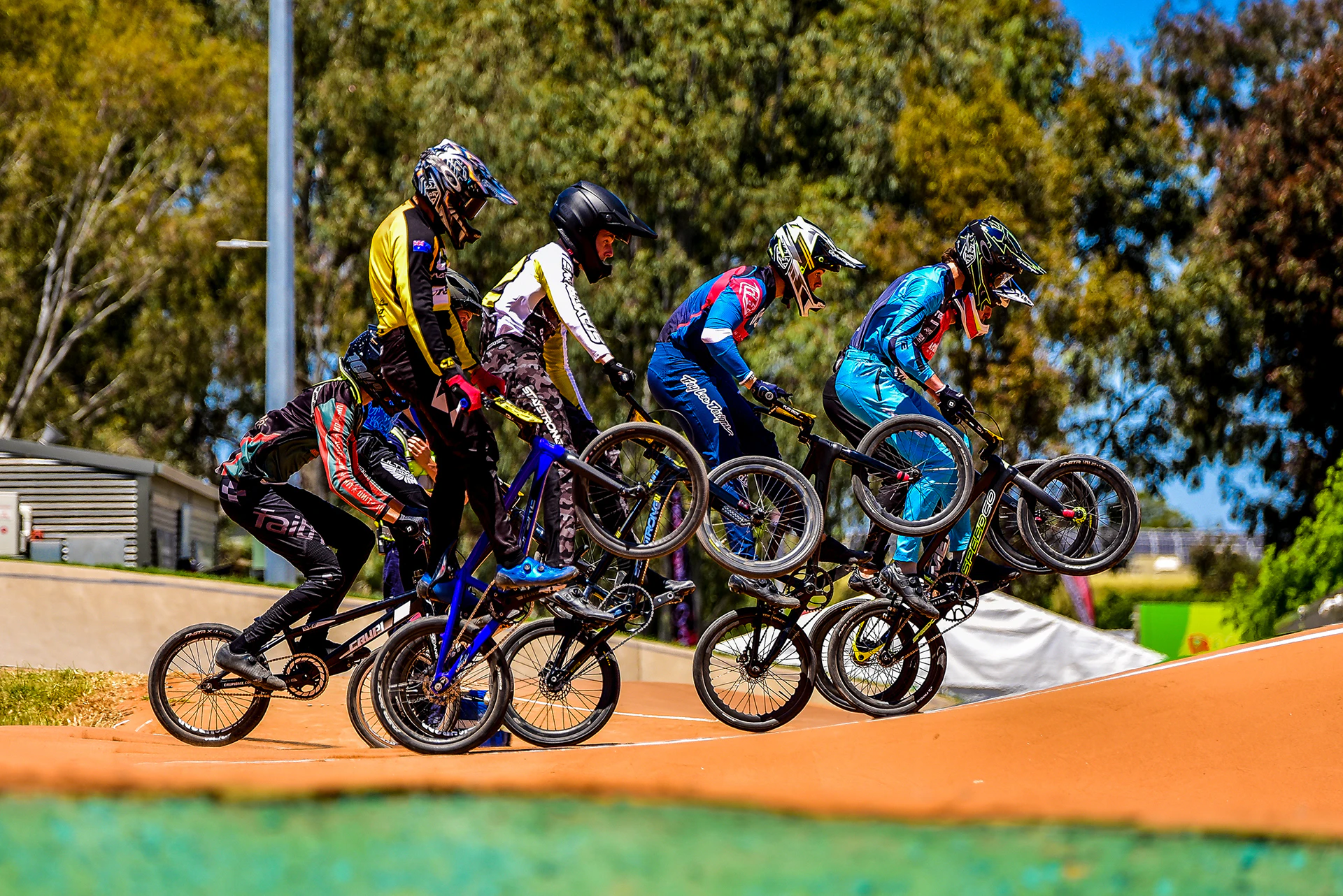 BMX riders mid jump in race