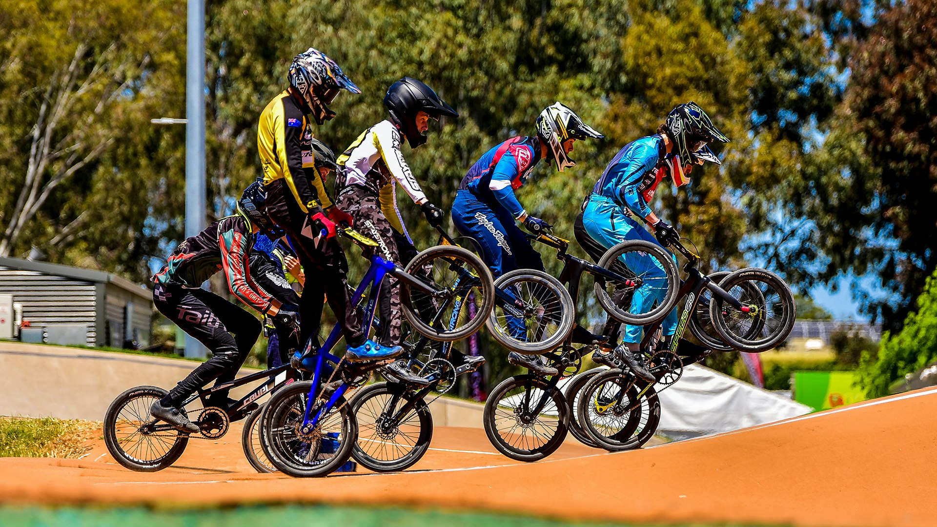 BMX riders mid jump in race