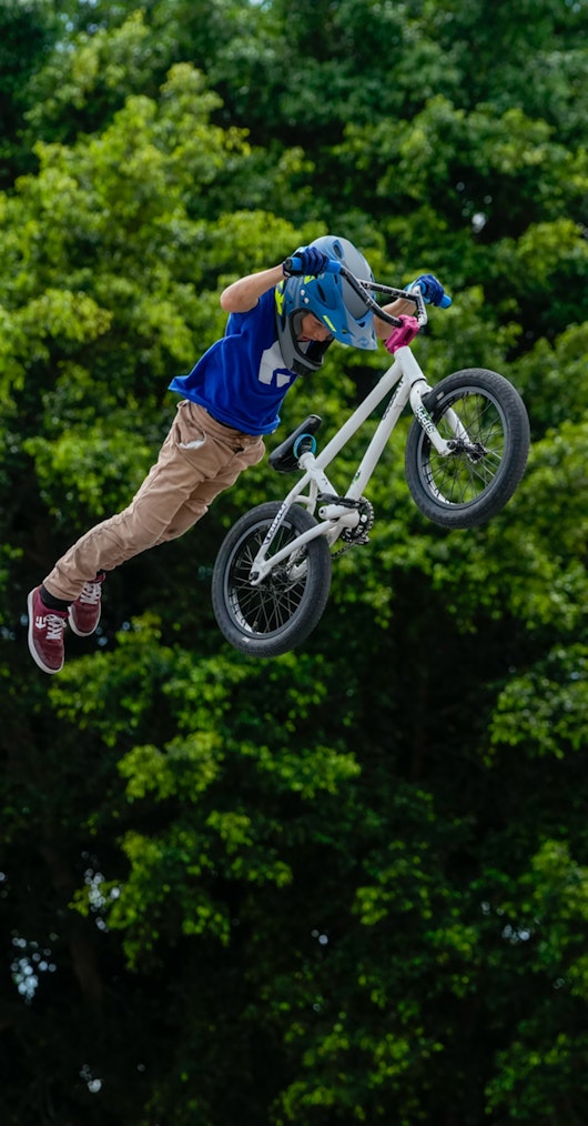 Young BMX rider in mid air jump