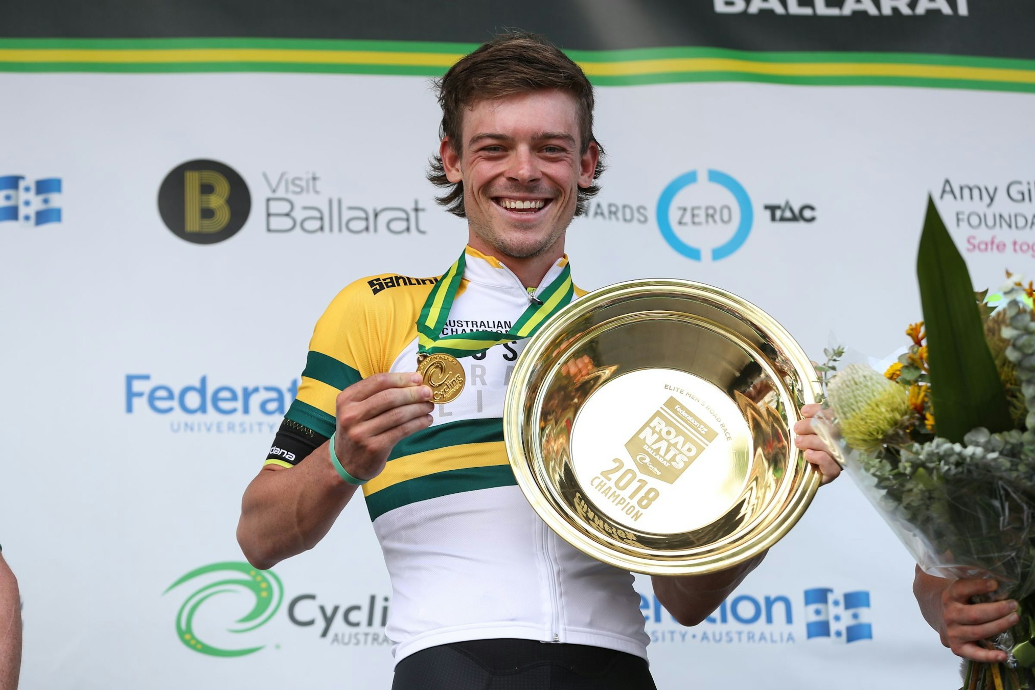 Alex Edmondson poses with gold medal, green and gold jersey and gold plate as the 2018 road race national champion in Ballarat. Con Chronis