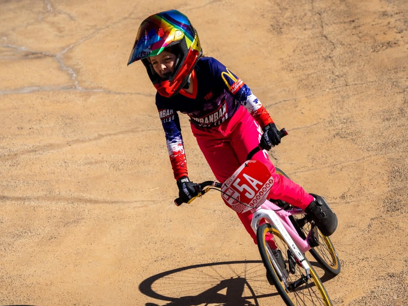 A young BMX racing rider with the 5A plate from Moranbah BMX Club rides on the track
