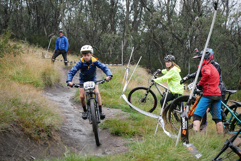 Mountain bike coach instructing downhill lesson