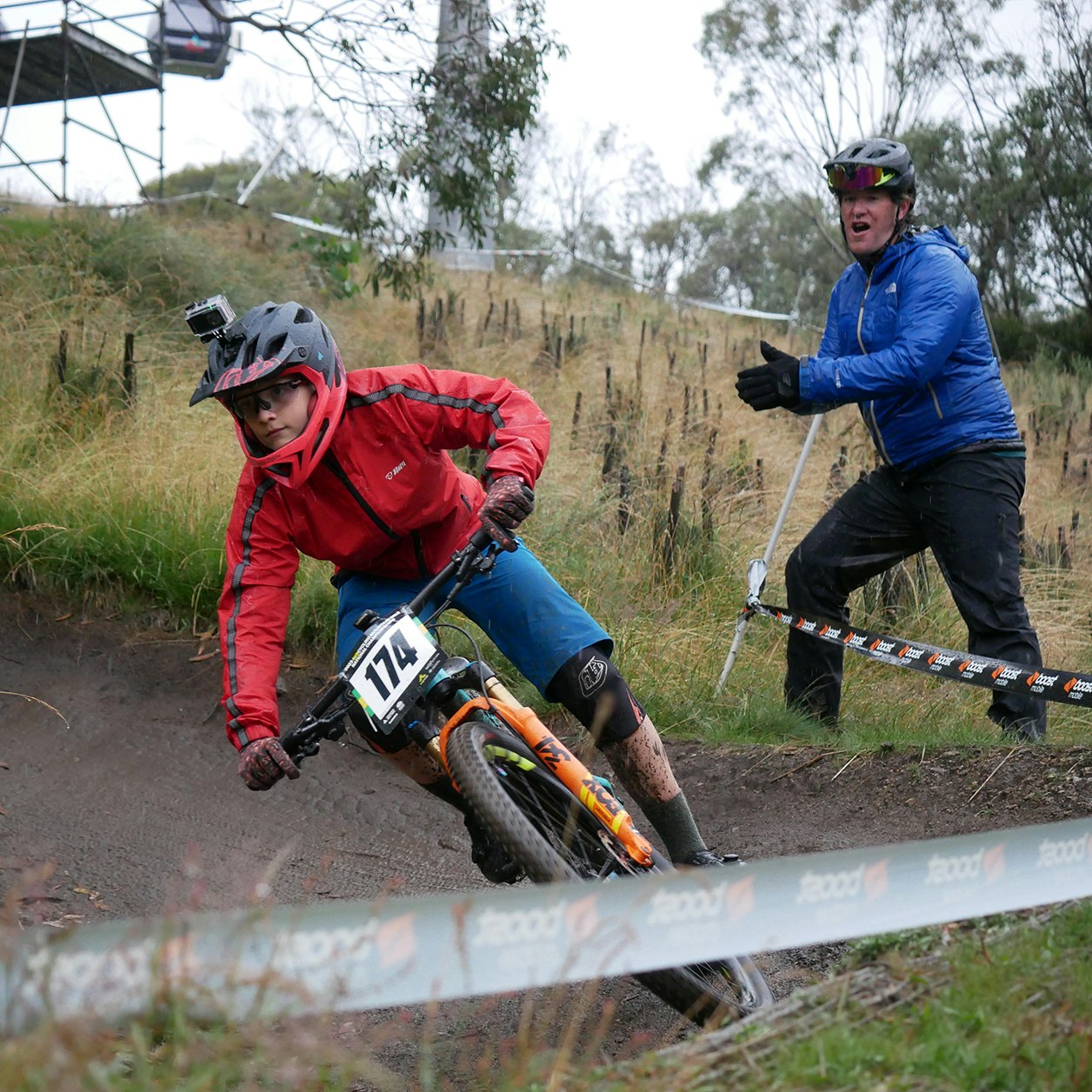 Mountain bike coach encouraging student on track