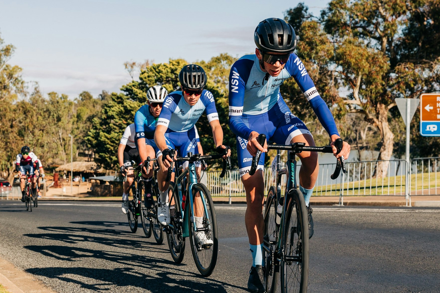 New South Wales junior road cyclists lead a group at the 2024 AusCycling Junior and Masters Road National Championships in Loxton, SA.