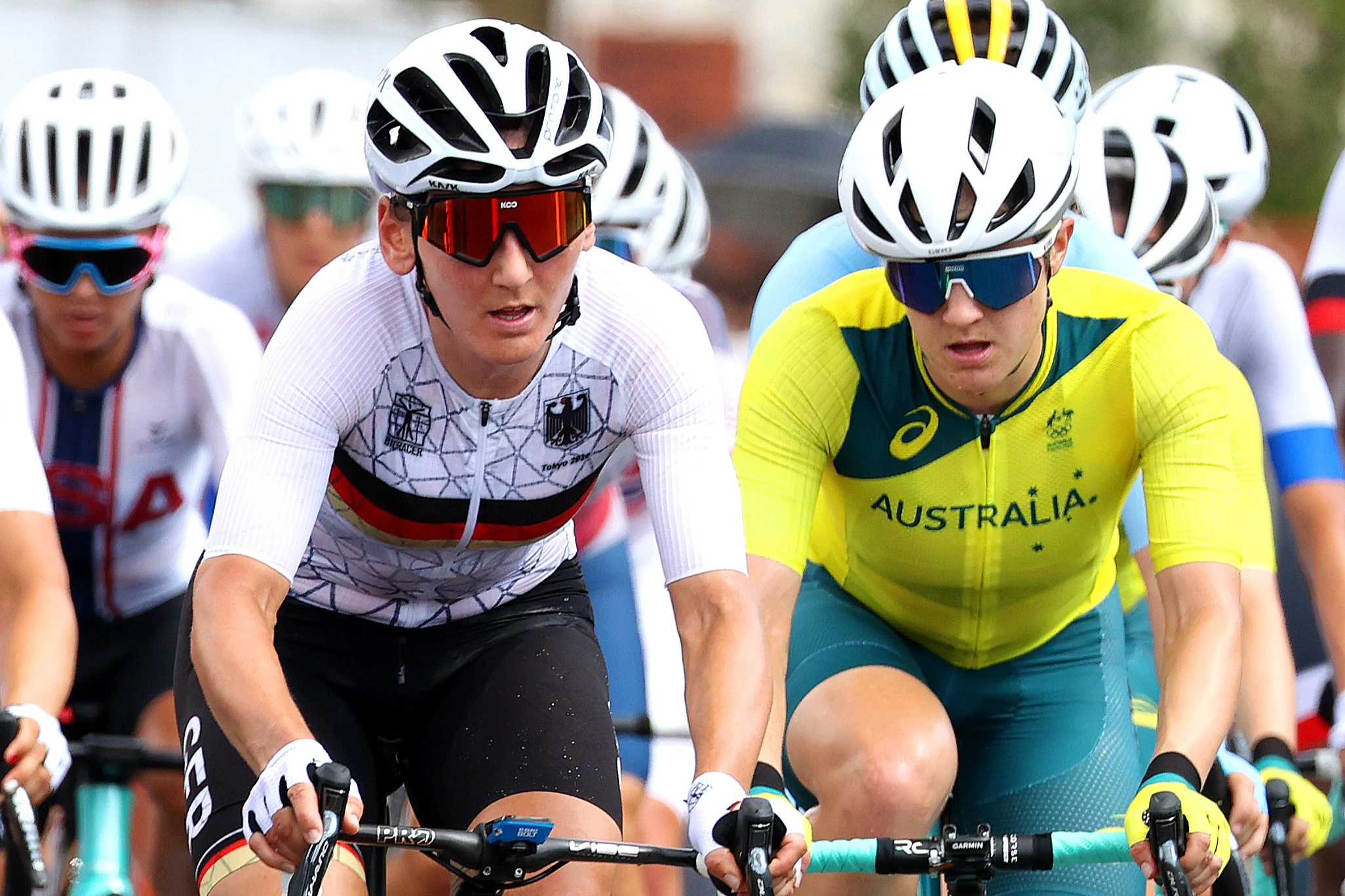 Australian cyclist Grace Brown next to a German rider during Tokyo 2020 Olympic Games women's road race
