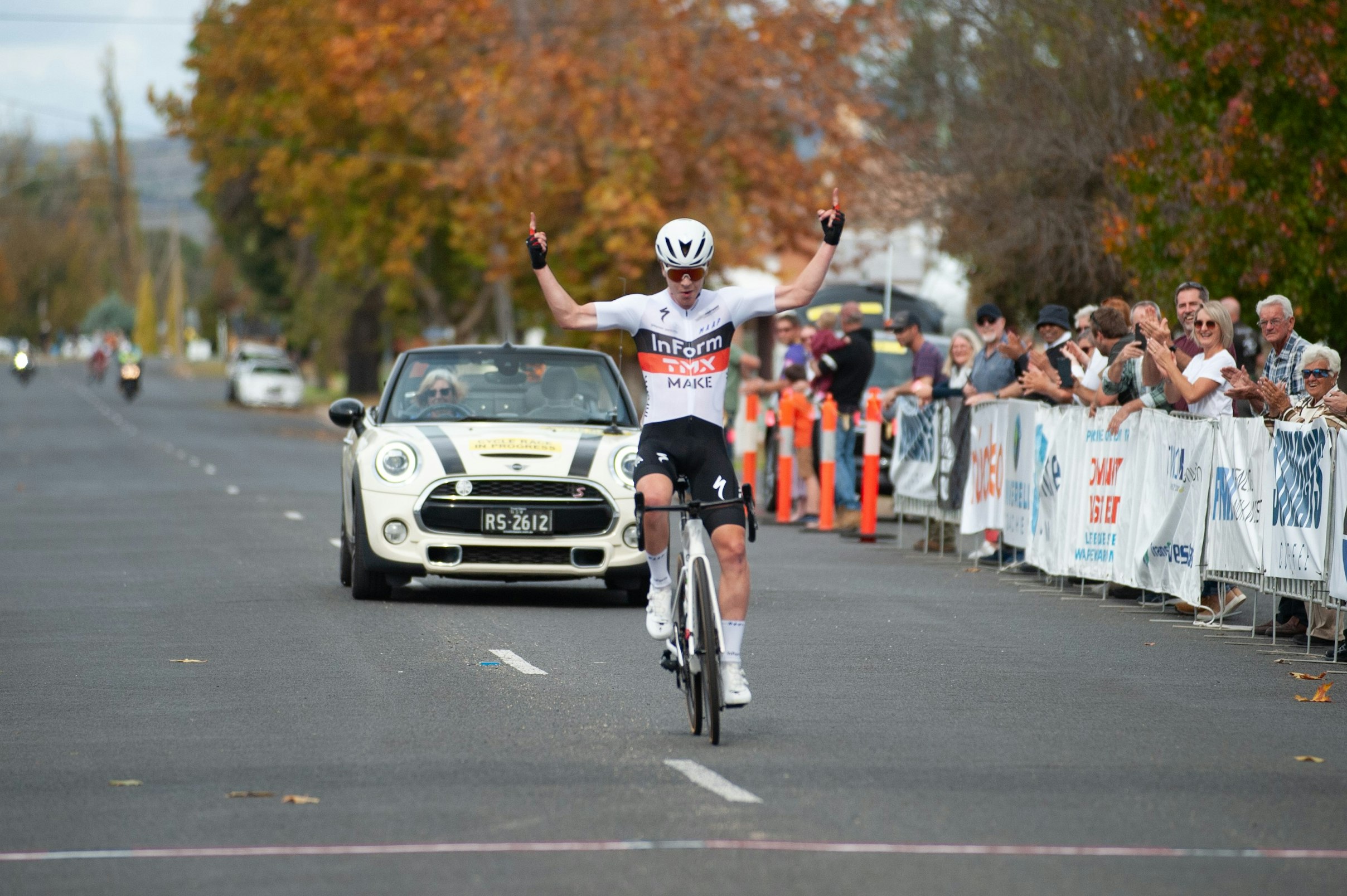 Rudy Porter puts his hands in the air as he crosses the line as solo winner of the 2021 Grafton to Inverell cycling race