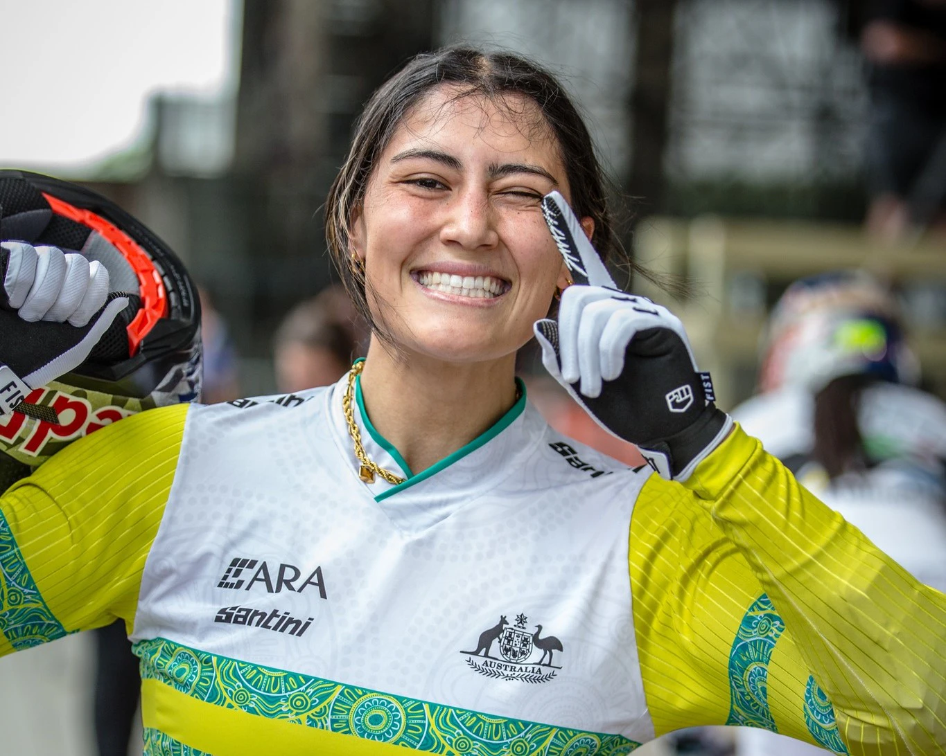 Australian BMX racer Saya Sakakibara smiles and raises her index finger to indicate she has won the UCI World Cup in 2024