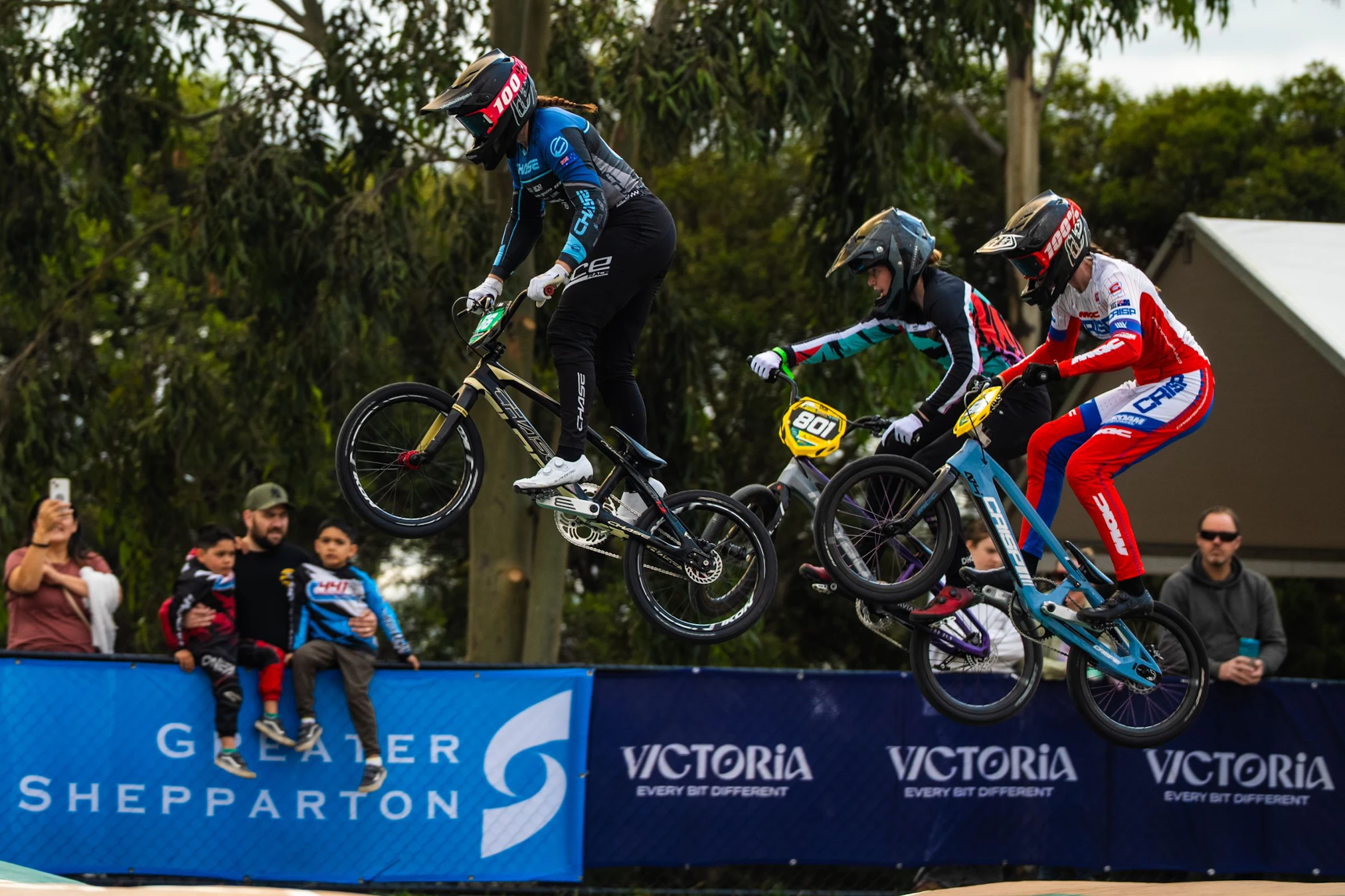 BMX Racing athletes jump in front of Greater Shepparton and Victoria signage at the 2026 GWM BMX Racing National Championships (Jake Oksanen)