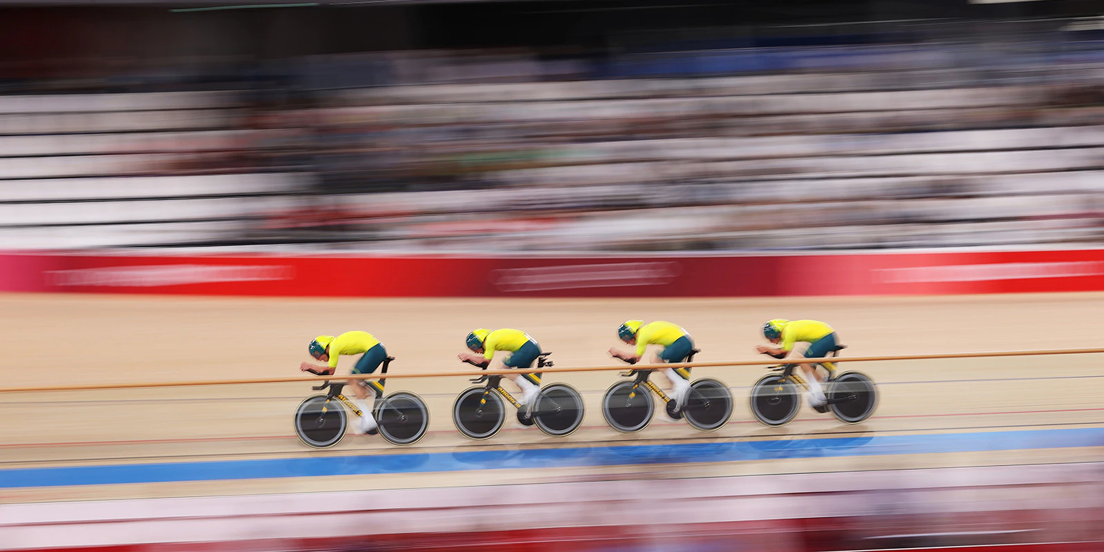 Blurred photo of the Australian team pursuit inside a velodrome at the Tokyo 2020 Olympic Games